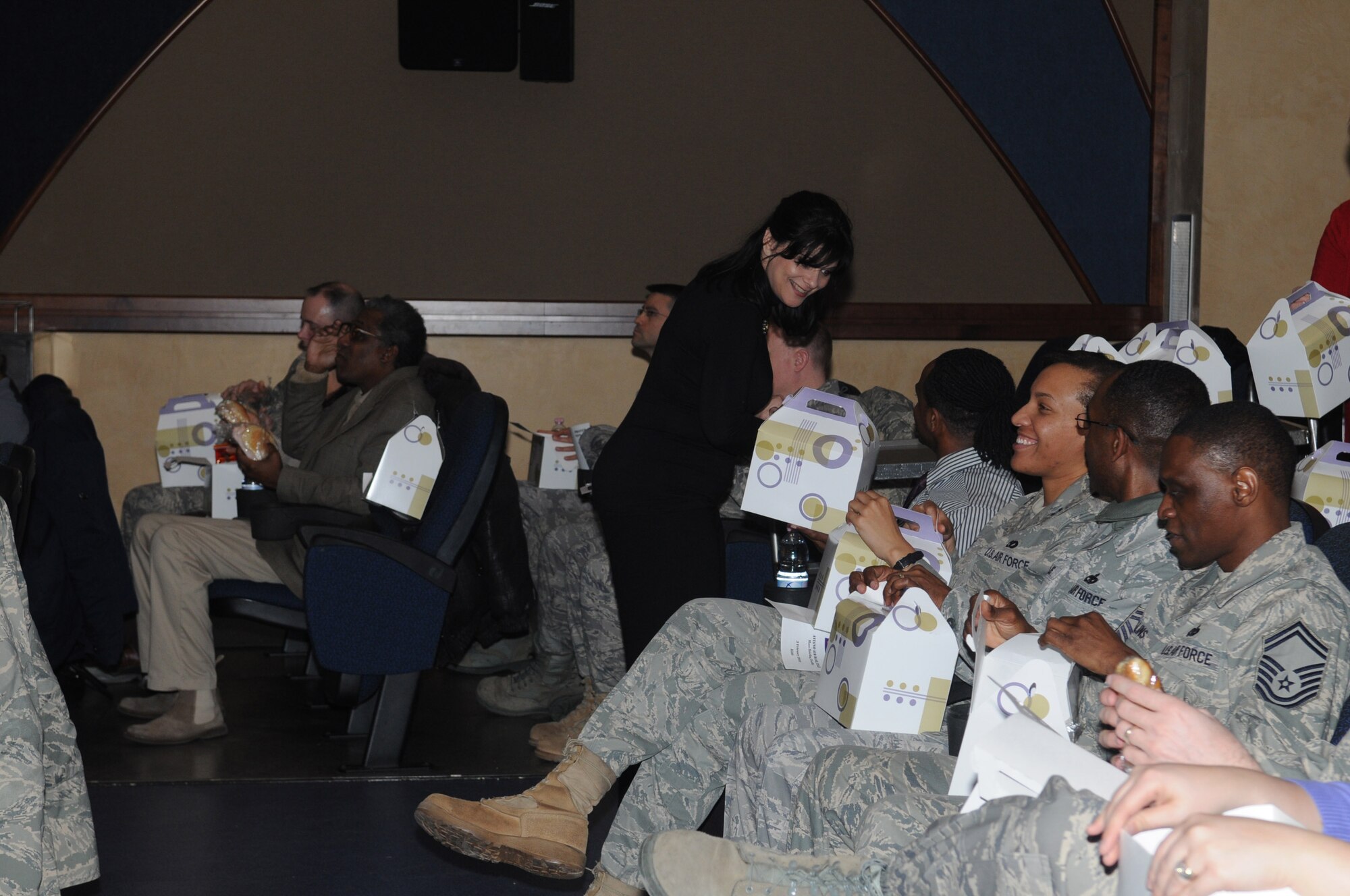 Katherine Lake, 31st Fighter Wing chapel office, hands out boxed lunches during the National Prayer Luncheon Feb. 3, 2010 at the Mass Briefing Facility at Aviano Air Base, Italy. The national event dates back to 1942 when prayer groups from the U.S. Senate and House of Representatives met weekly. (Air Force photo/Staff Sgt. Mercedes Crossland)