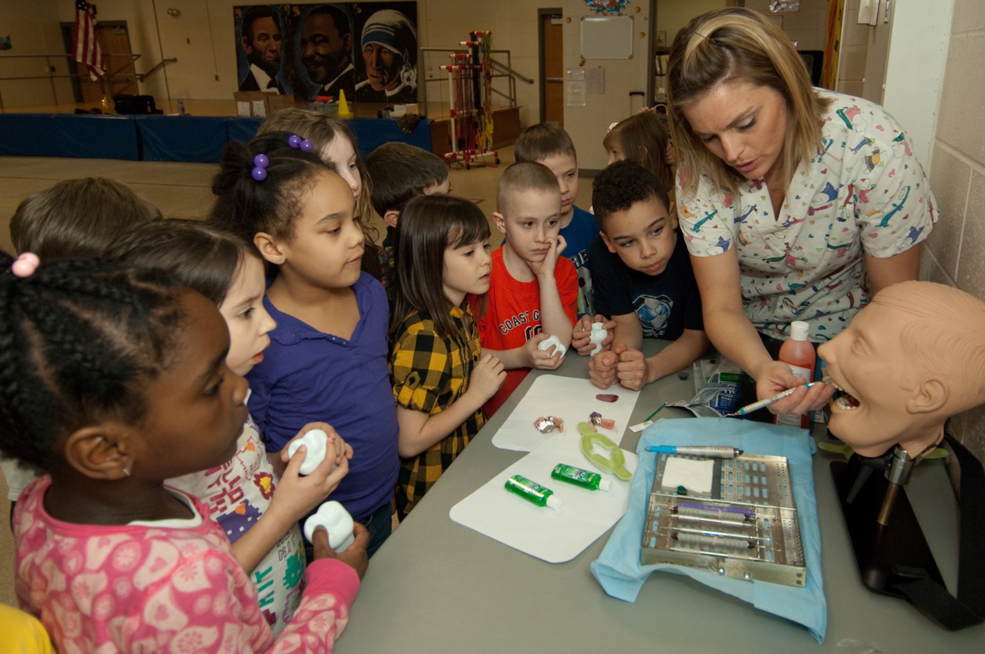 During a visit with Hanscom Primary School first-graders, Staff Sgt. Kristin Hays, 66th Dental Flight dental hygienist, demonstrates the instruments used to clean patients’ teeth during dental clinic visits.  Dental clinic personnel are visiting Hanscom schools throughout February to promote National Children’s Dental Health Month.  (U.S. Air Force photo by Rick Berry)