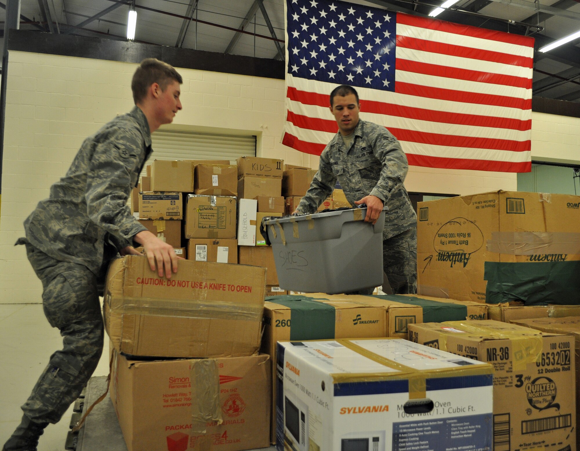 100201-F-2174W-001 -- RAF MILDENHALL, England -- Airman Andrew Pinette and Airman 1st Class Matthew Rohrs, both from the 352nd Maintenance Squadron, palletize boxes of donations for the Haiti relief effort.  These Airmen helped coordinate the 352nd Special Operations Group donation effort which resulted in the collection of about 15,000 pounds of items ranging from toiletries to food to clothing.  These items will assist over 20,000 families.  (U.S. Air Force photo/Tech. Sgt. Marelise Wood)