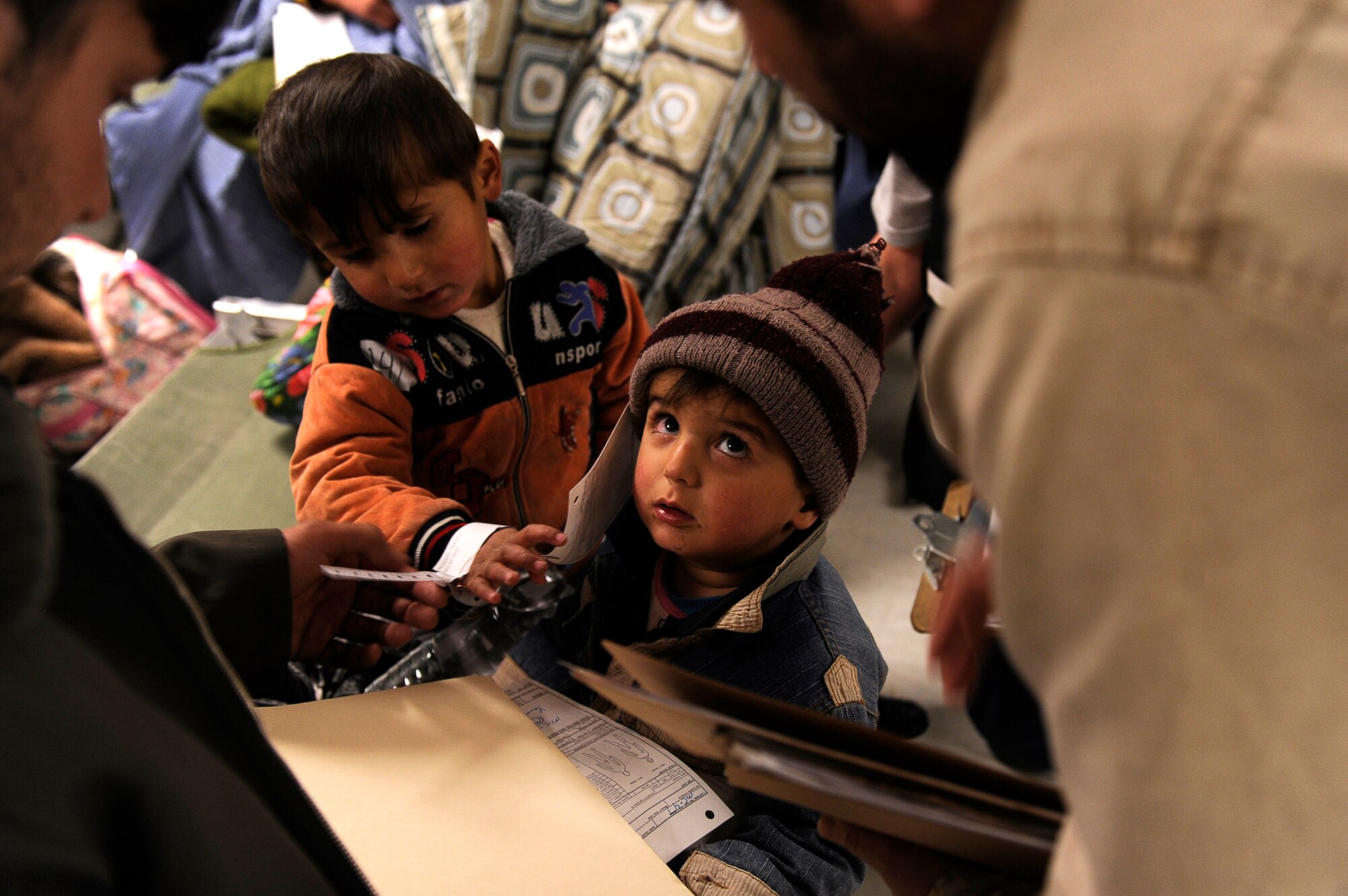 A young avalanche survivor watches as doctors and his father talk at Craig Joint Theater Hospital, Bagram Airfield, Feb. 9, 2010. Dozens of Afghans were taken to Bagram Airfield after an avalanche struck a mountain pass in the Parwan province in north eastern Afghanistan. (U.S. Air Force photo by/ Tech. Sgt. Jeromy K. Cross/released)