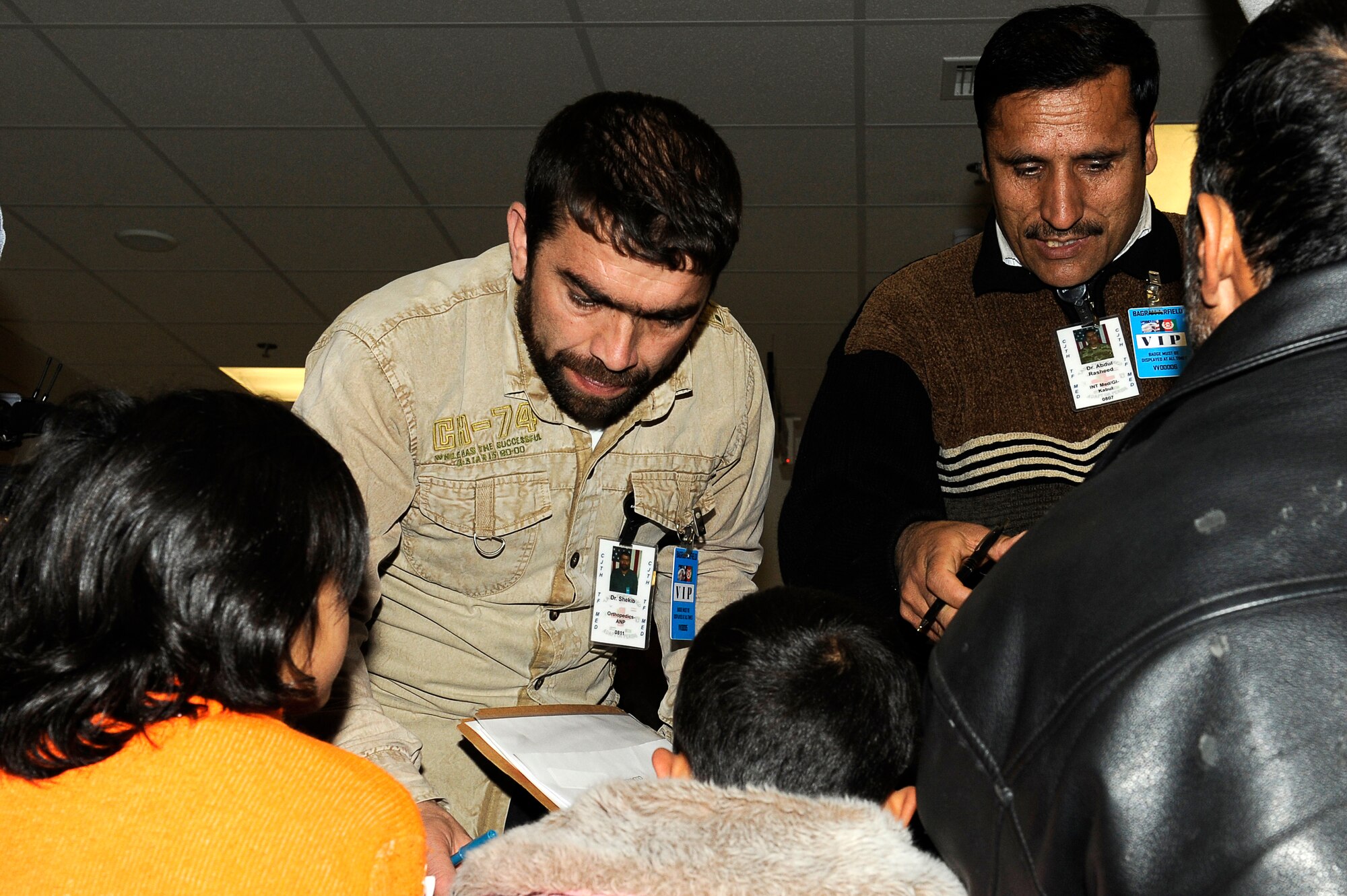 Afghan doctors Shekib Hassanzada (left) and Abdul Rasheed assess avalanche survivors who were medically evacuated to Craig Joint Theater Hospital, Bagram Airfield, Feb. 9, 2010. Dozens of Afghans were taken to Bagram Airfield after an avalanche struck a mountain pass in the Parwan province in north eastern Afghanistan. (U.S. Air Force photo by/ Tech. Sgt. Jeromy K. Cross/released)