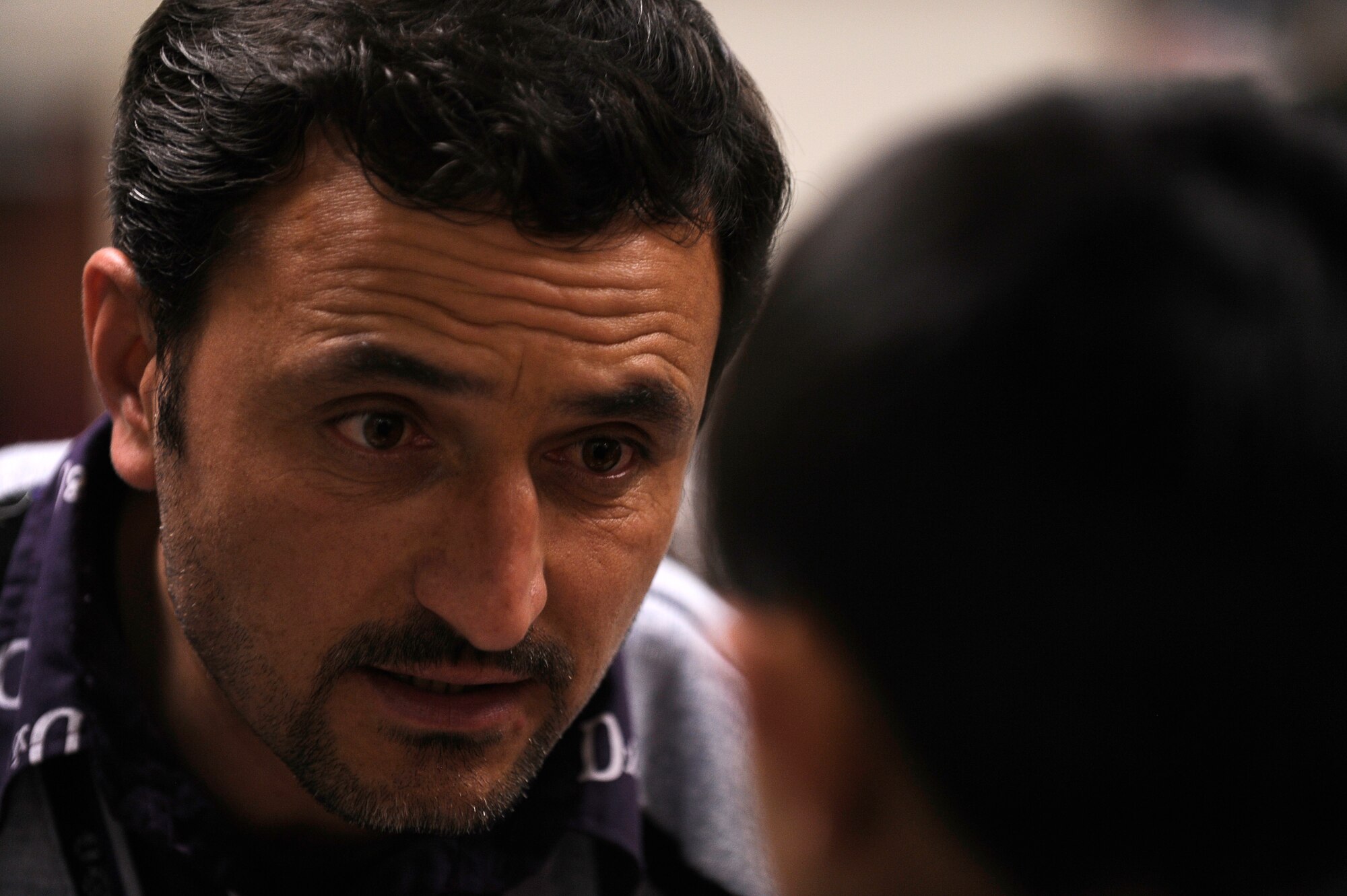 Afghan Dr. Abdul Hashim talks with a young avalanche survivor at Craig Joint Theater Hospital, Bagram Airfield, Feb. 9, 2010. Dozens of Afghans were taken to Bagram Airfield after an avalanche struck a mountain pass in the Parwan province in north eastern Afghanistan. (U.S. Air Force photo by/ Tech. Sgt. Jeromy K. Cross/released)