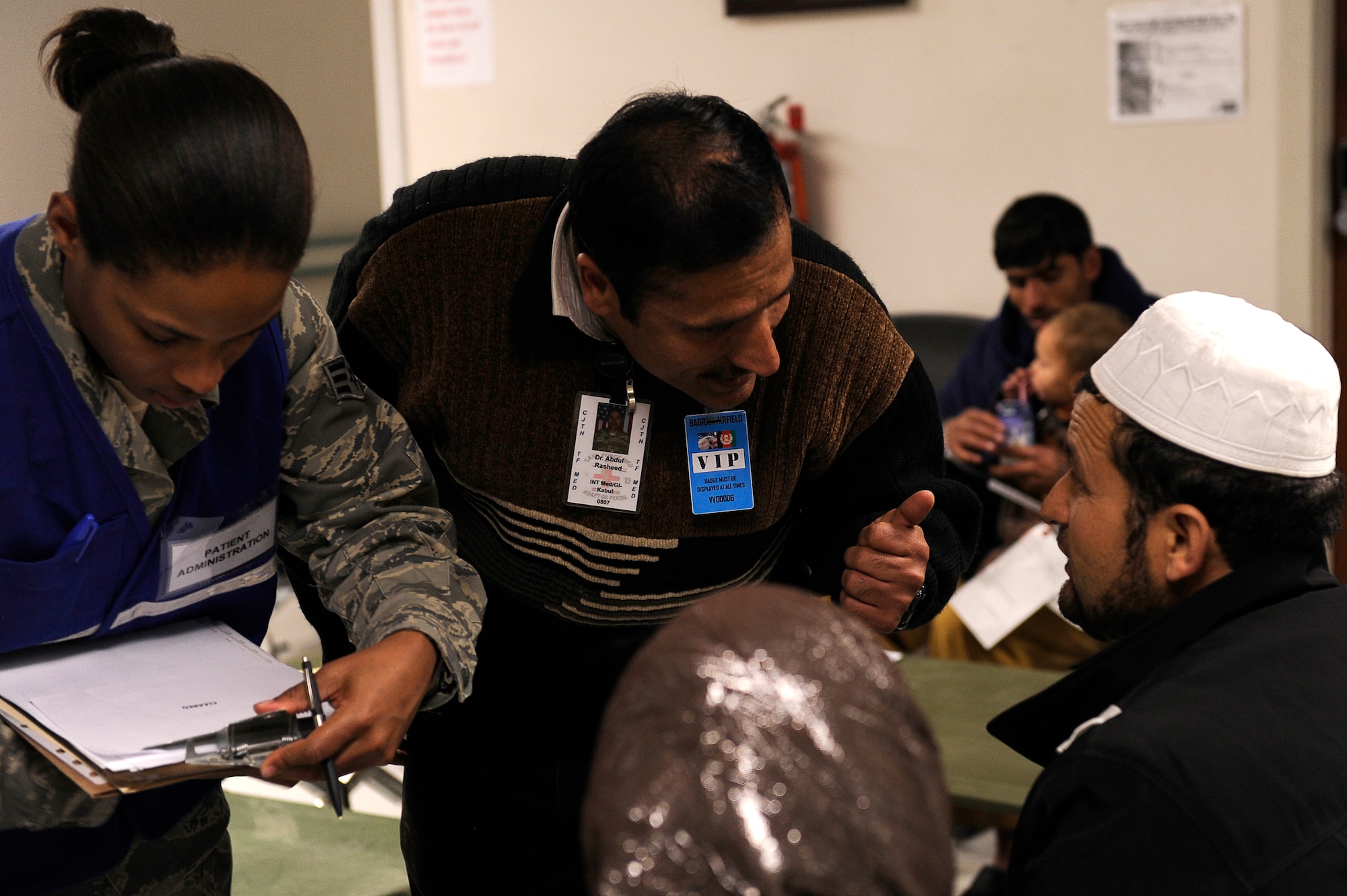 Afghan Dr. Abdul Rasheed and U.S. Senior Airmen Katrevious Swift, 455th Expeditionary Medical Group, talk with an avalanche survivor at Craig Joint Theater Hospital, Bagram Airfield, Feb. 9, 2010. Dozens of Afghans were taken to Bagram Airfield after an avalanche struck a mountain pass in the Parwan province in north eastern Afghanistan. (U.S. Air Force photo by/ Tech. Sgt. Jeromy K. Cross/released)
