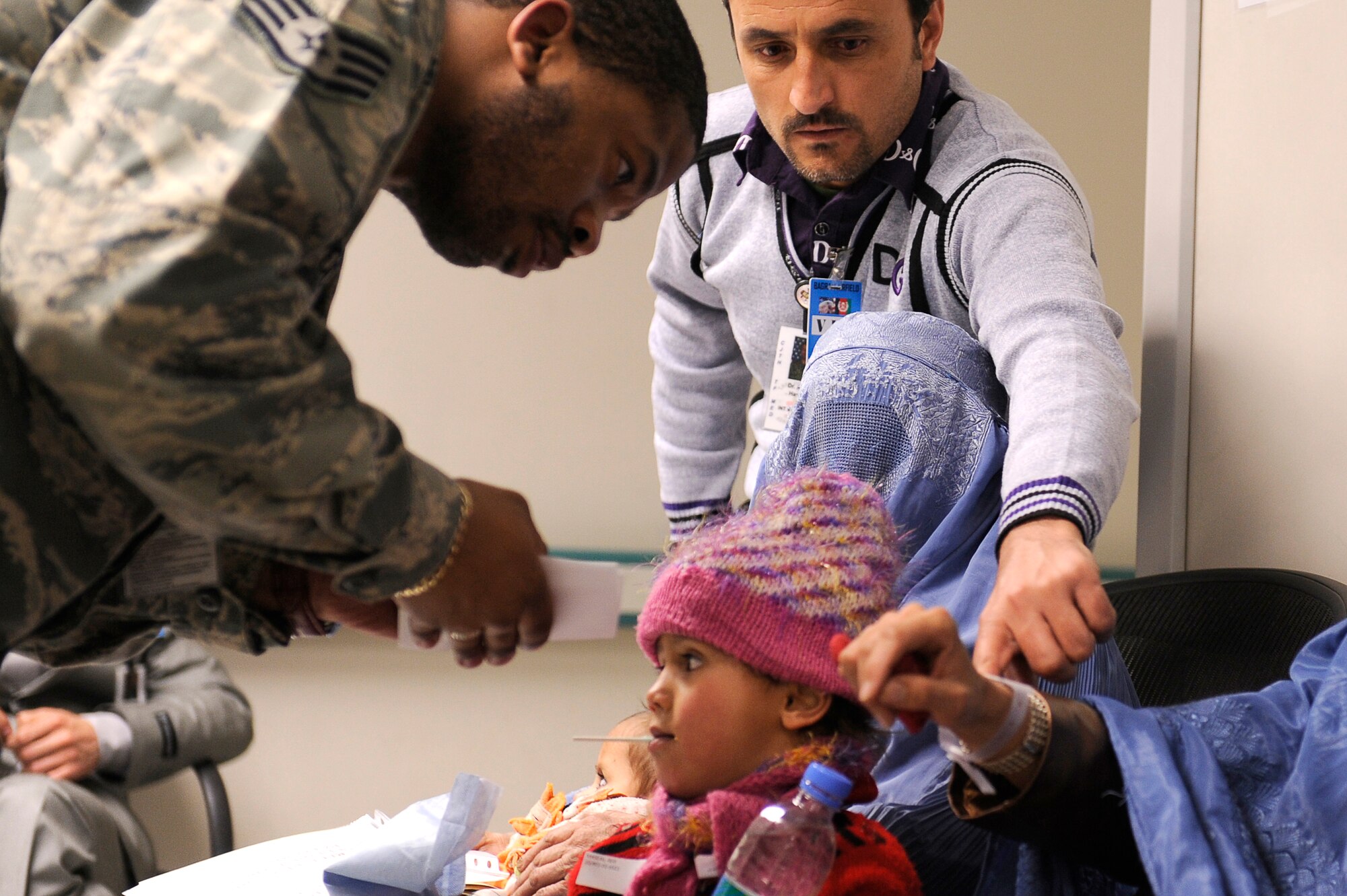 Afghan Dr. Abdul Hashim points out information to U.S. Air Force Staff Sgt. Russell Poole from the 455th Expeditionary Medical Group at Craig Joint Theater Hospital, Bagram Airfield, Feb. 9, 2010. Dozens of Afghans were taken to Bagram Airfield after an avalanche struck a mountain pass in the Parwan province in north eastern Afghanistan. (U.S. Air Force photo by/ Tech. Sgt. Jeromy K. Cross/released)