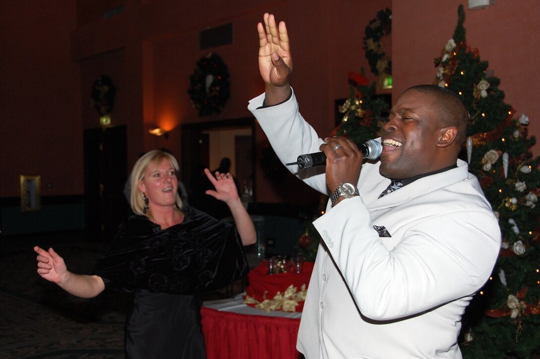 SSgt Andre Rascoe entertains an audience at a 2009 Holiday performance in Italy with the popular music ensemble, Touch n' Go.