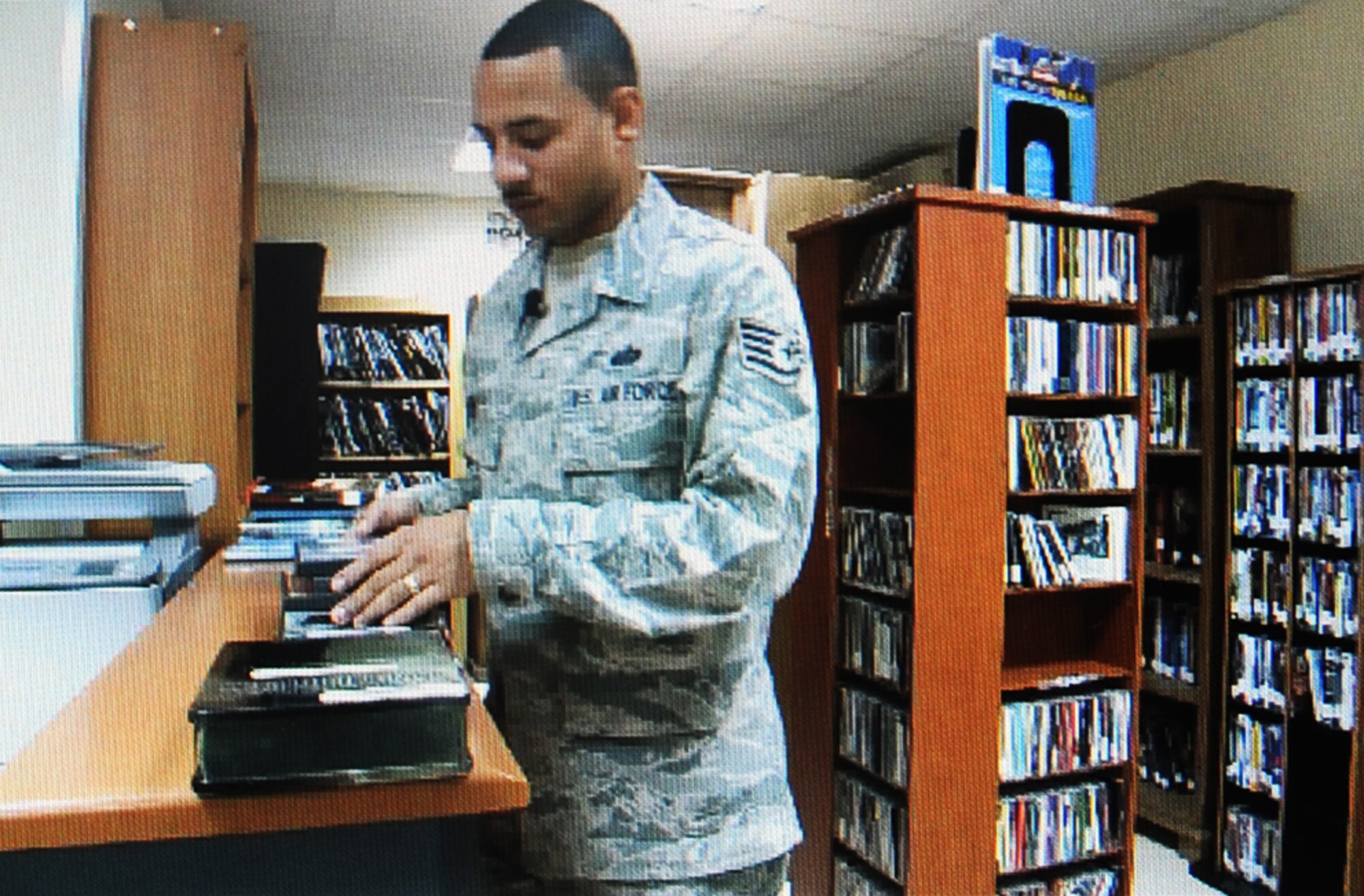 Staff Sgt. Michael Sala, a services craftsman deployed with the 380th Expeditionary Force Support Squadron, puts away movies while managing activities for the 380th Air Expeditionary Wing Learning Resources Center at a non-disclosed base in Southwest Asia on Feb. 10, 2010. He is deployed from the 87th FSS at Joint Base McGuire-Dix-Lakehurst, N.J., and his hometown is Bronx, N.Y.  (U.S. Air Force Photo/Staff Sgt. Nathan Delgado/Released)