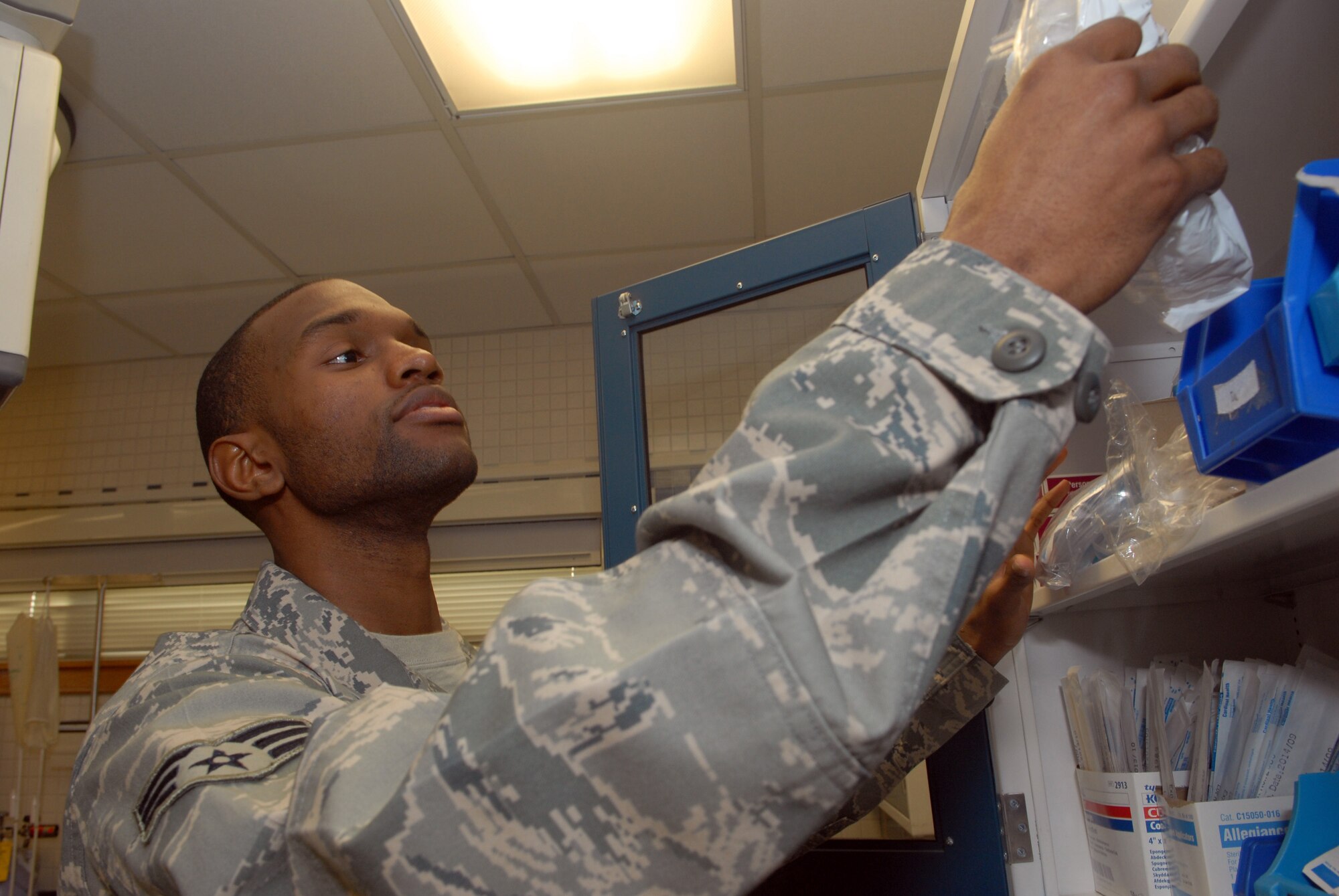 KUNSAN AIR BASE, Republic of Korea -- Senior Airman Isaac Adimora, 8th Medical Operation Squadron aerospace medical technician, looks through medical inventory at the base clinic Feb. 4. (U.S. Air Force photo/Senior Airman Roy Lynch)