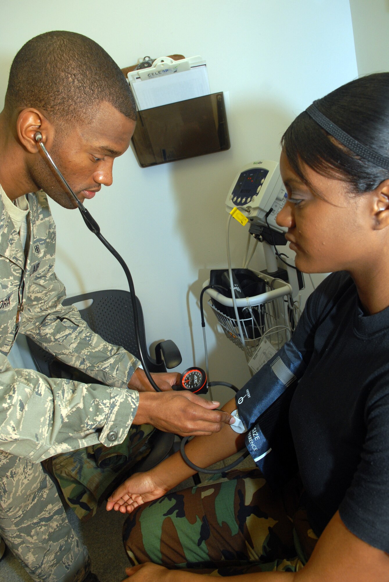 KUNSAN AIR BASE, Republic of Korea -- Senior Airman Isaac Adimora, 8th Medical Operation Squadron aerospace medical technician, checks Senior Airman Chanel Kendrick, 8th MDOS aerospace medical technician, blood pressure at the base clinic Feb. 4. Aerospace medical technicians provide inpatient and outpatient care as well as emergency response. (U.S. Air Force photo/Senior Airman Roy Lynch)