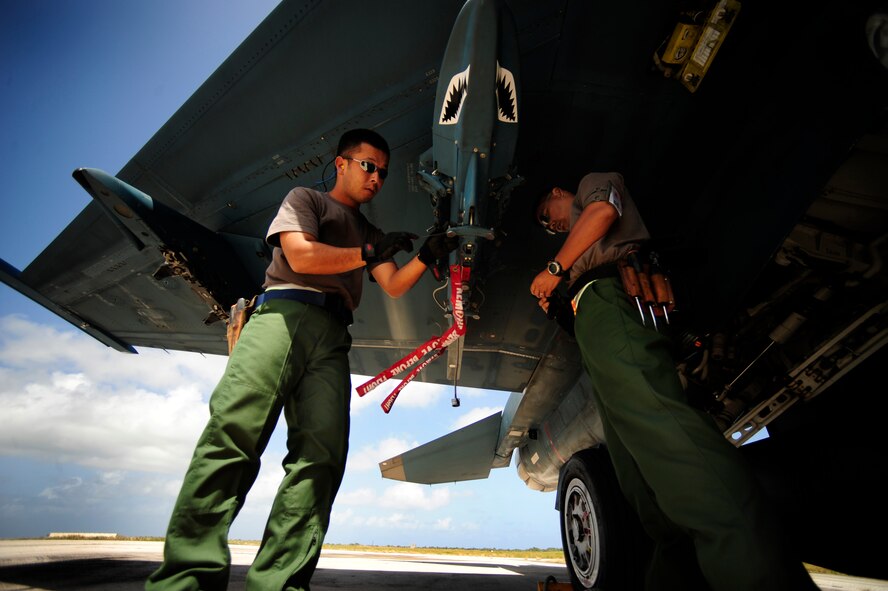 Japanese maintenance crew members of the 8th Combat Wing, 6th TF Squadron, Tsuiki AB, Japan, prepare their F2 for ammunitions during Cope North on Andersen Air Force Base, Guam on Feb. 9, 2010. The United States Air Force and the Japanese Air Self-Defense Force conduct Cope North annually to increase combat readiness and interoperability, concentrating on coordination and evaluation of air tactics, techniques, and procedures. The ability for both nations to work together increases their preparedness to support real-world contingencies.(USAF photo by Staff Sgt. Andy M. Kin)