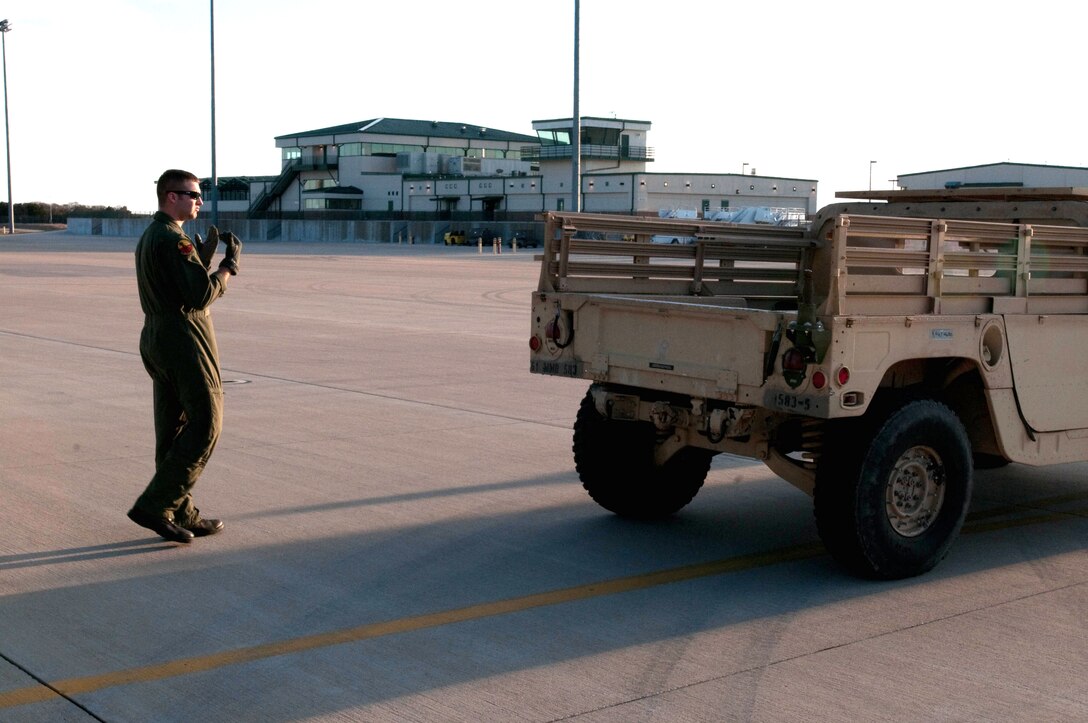 Tech. Sgt. Tyler Lingerfelt, 139th Airlift Wing, Mo. Air National Guard, guides a humvee onto their C-130 at Fort Hood, Tx, for another mission to Port-Au-Prince, Haiti on February 9, 2010. (U.S. Air Force photo by Master Sgt. Shannon Bond/Released)