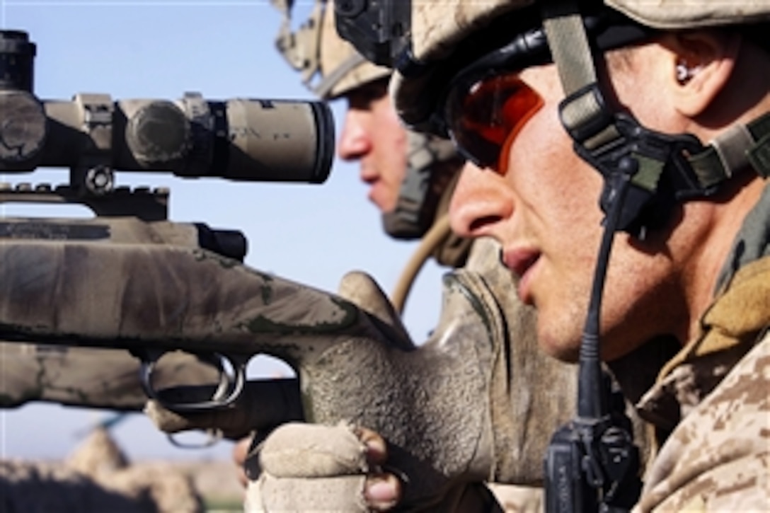 U.S. Marine Corps Lance Cpls. Keith B. Lawson and Spence G. Press work
together to identify targets as Taliban fighters approached from Marjeh toward their position at the “Five Points” intersection, Helmand province, Afghanistan, Feb. 9, 2010. Lawson and Spence, both scout snipers, are assigned to Charlie Company, 1st Battalion, 3rd Marine Regiment, which conducted an assault earlier that morning to seize the area.