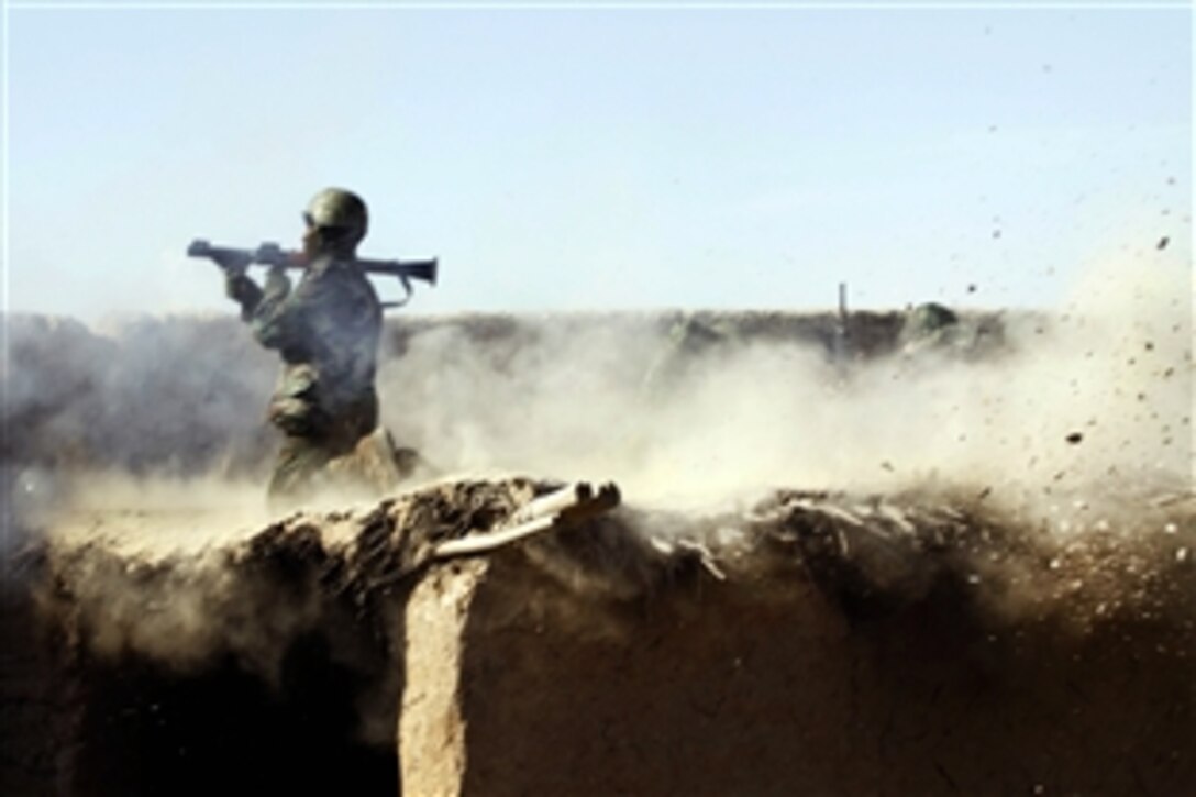 An Afghan soldier fires a rocket-propelled grenade at Taliban insurgents firing on their position at the “Five Points” intersection in Marjeh in Afghanistan's Helmand province, Feb. 9, 2010. Afghan soldiers joined U.S. Marines assigned to Charlie Company, 1st Battalion, 3rd Marine Regiment, as they conducted an assault earlier that morning to seize the key intersection linking the northern area of the insurgent stronghold of Marjeh with the rest of Helmand province.