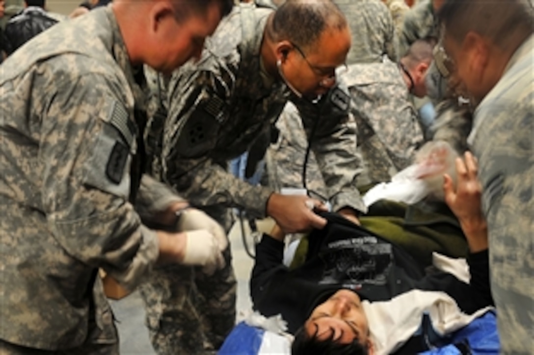 U.S. Army soldiers treat of one of the survivors of the Salang Pass avalanche at the triage area on Bagram Airfield in Parwan, Afghanistan, Feb. 9, 2010. Several survivors were treated and feed a hot meal as a part of the Afghanistan Avalanche Recovery Mission. 