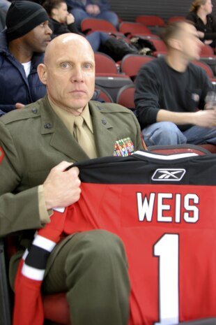 Sergeant Major George J. Weis, Inspector-Instructor sergeant major of 6th Motor Transport Battalion, 4th Marine Logistics Group, Marine Forces Reserve, displays a jersey presented by the New Jersey  Devils of the National Hockey League prior to their game Feb. 10.  Weis was honored with the official sweater autographed by the Devils' players in recognition of his 29 years of faithful service to the Marine Corps. He will retire in a ceremony Feb. 19. (Official Marine Corps photo by Gunnery Sgt. Christopher Randazzo)