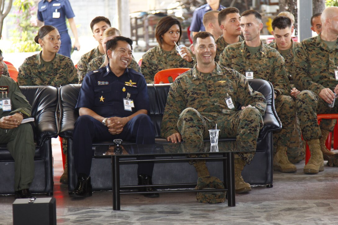 Col. Robert Brassaw, commanding officer for MAG-36, and Group Captain “Rocket” Chatarasopa, Korat Royal Thai Air Force commanding officer, sit and enjoy a performance put on by the young ladies of Narisawat welfare Protection and Vocational Training Centre for Women here in Thailand Feb. 10.