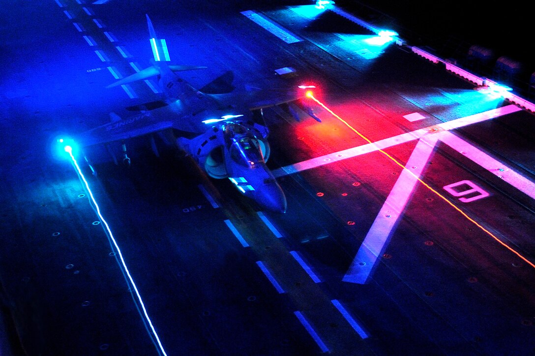 British Royal Air Force Flight Lt. Douglas McKay, an exchange pilot with Marine Attack Squadron 311, takes off from the flight deck of the USS Peleliu during night operations in the Pacific Ocean Feb. 10, 2010. The squadron trained aboard the Peleliu in order to obtain its aircraft carrier qualifications and prepare for its upcoming deployment with the 15th Marine Expeditionary Unit in May. Approximately 10 pilots and 15 support and maintenance personnel participated in the exercise.