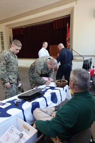 MARINE CORPS BASE CAMP LEJEUNE, N.C.-  Vernon Jeter (right), a human resources representative with WB Moore Company out of Charlotte, N.C., talks to Marines about job openings during the Employer Recruitment Day sponsored by Marine Corps Community Services, which was held Feb. 11. The event is the first of its kind held by MCCS.
