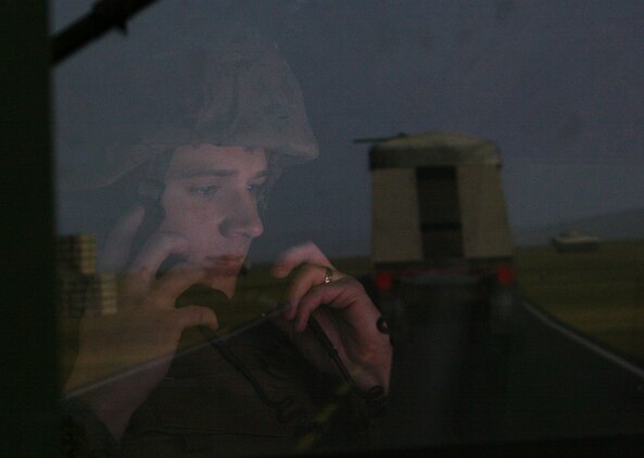 Sgt. Cory L. Marek, Military Police Company, Combat Logistics Regiment 27, 2nd Marine Logistics Group, communicates with the combat operations center as the convoy commander during the combat convoy simulation training here, Feb. 17-19, 2010.  The CCS trainers provide an immersive training environment for convoy operations to include basic procedures for driver, gunner, and passengers in tactical scenarios, related to combat operations.