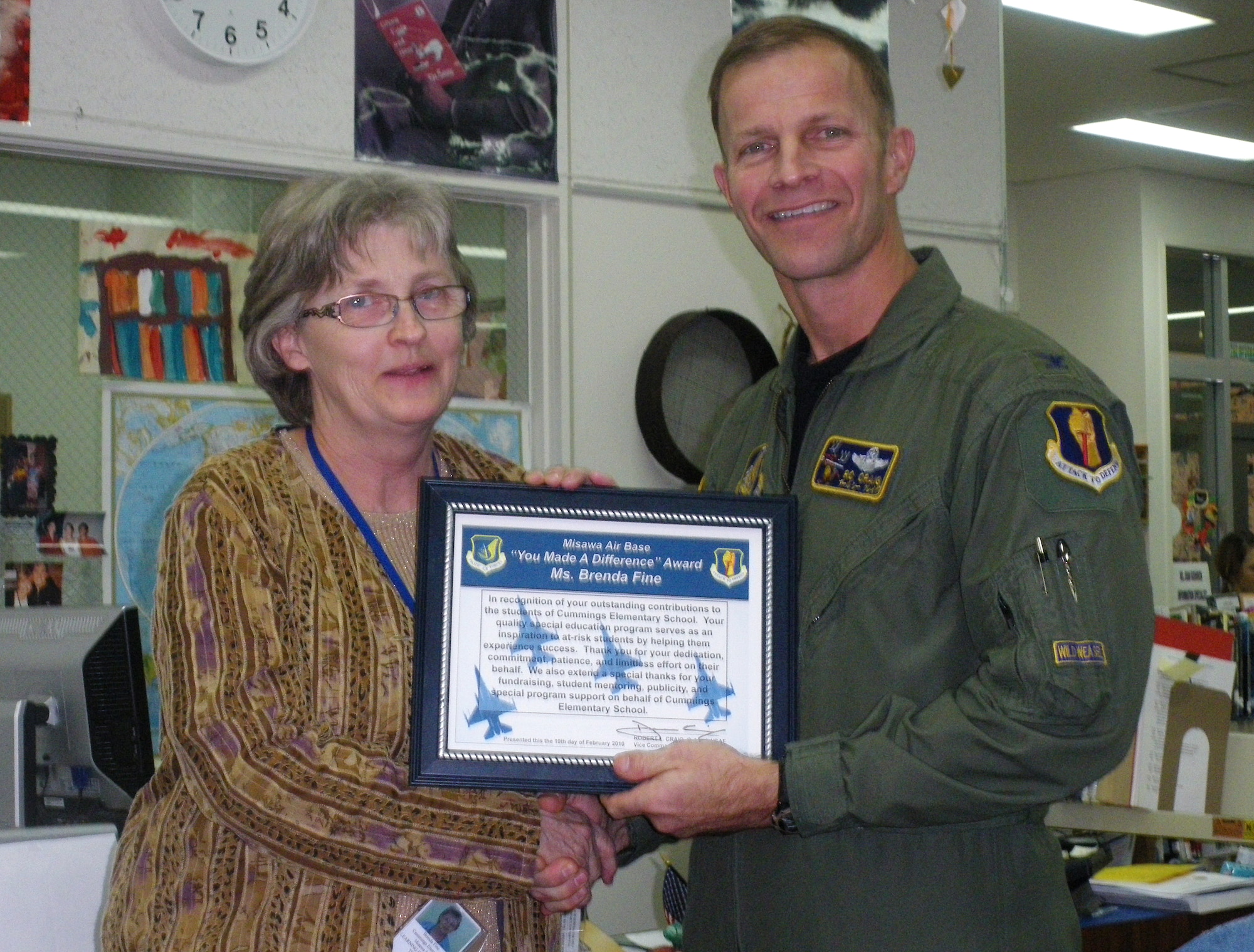MISAWA AIR BASE, Japan -- Col. RC Craig, 35th Fighter Wing vice commander, presents the wing's "You Make a Difference" award to Ms. Brenda Fine, Special Education Program teacher, Feb. 10. Ms. Fine has been teaching at Misawa Air Base for more than 15 years. (U.S. Air Force photo/Staff Sgt. Chad Strohmeyer)