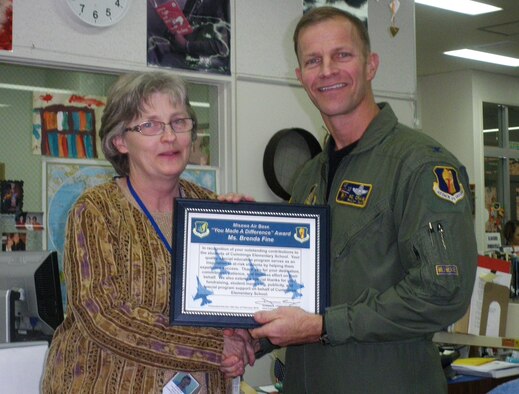 MISAWA AIR BASE, Japan -- Col. RC Craig, 35th Fighter Wing vice commander, presents the wing's "You Make a Difference" award to Ms. Brenda Fine, Special Education Program teacher, Feb. 10. Ms. Fine has been teaching at Misawa Air Base for more than 15 years. (U.S. Air Force photo/Staff Sgt. Chad Strohmeyer)