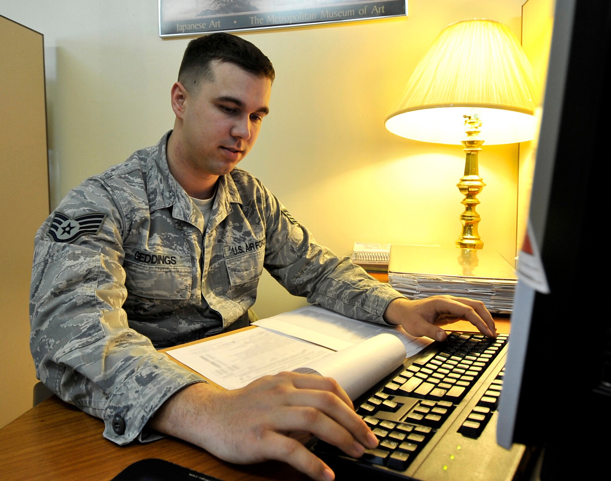 MISAWA AIR BASE, Japan -- Staff Sgt. Jason Geddings, tax center volunteer, fills in customer?s tax information Feb. 11. Volunteers received training through a four-day long online class provided by the Internal Revenue Service. (U.S. Air Force photo/Staff Sgt. Chad C. Strohmeyer)