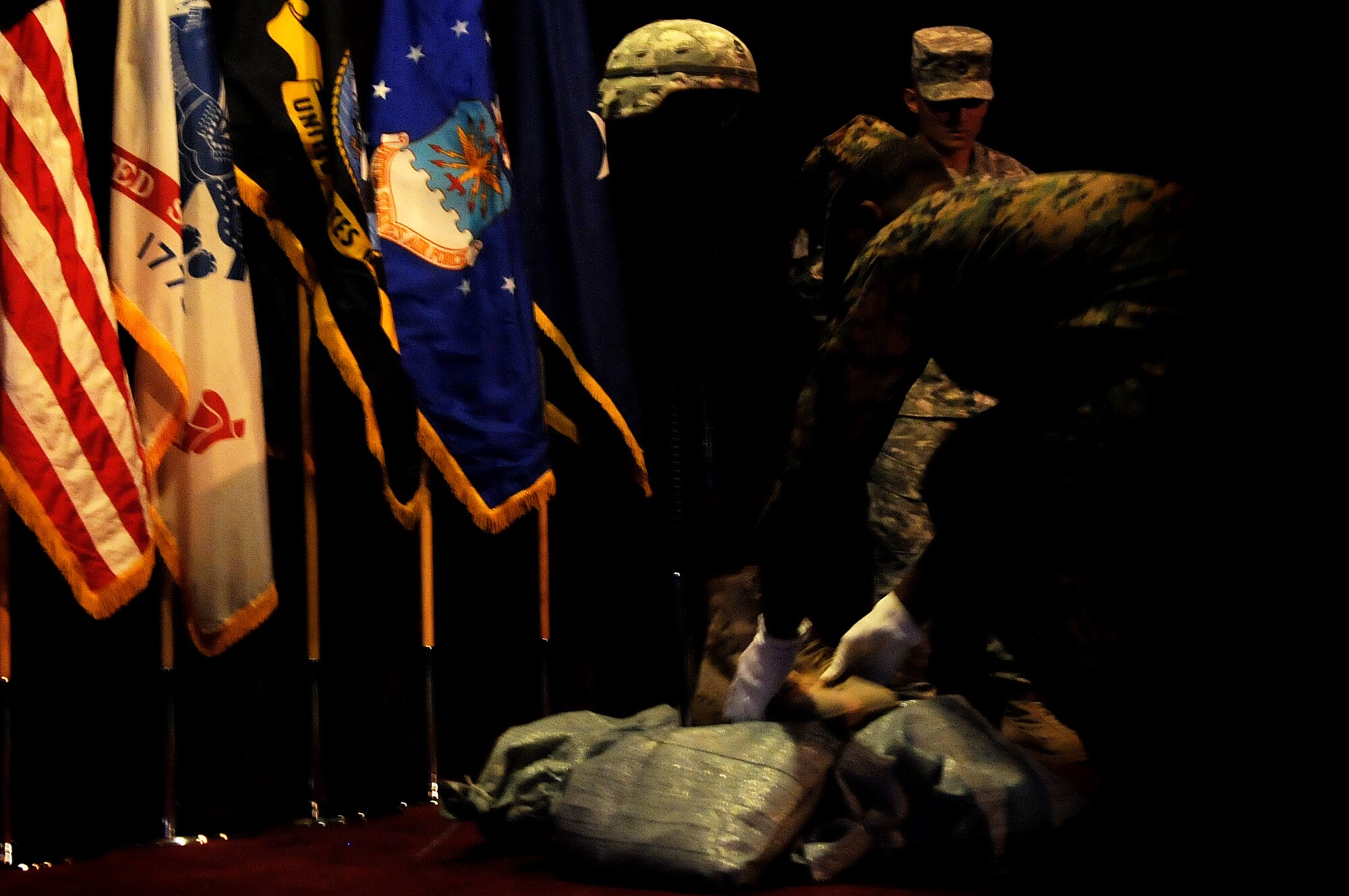 Members of the United States Army, Air Force and Navy perform a remembrance vigil at the Joint Service Non-Commissioned Officer Academy graduation at Kadena's Erwin Professional Military Education Center, Feb 11. The Erwin PME Center conducts a leadership course for enlisted servicemembers in the rank of E-6. (U.S. Air Force photo / Senior Airman Amanda N. Grabiec)