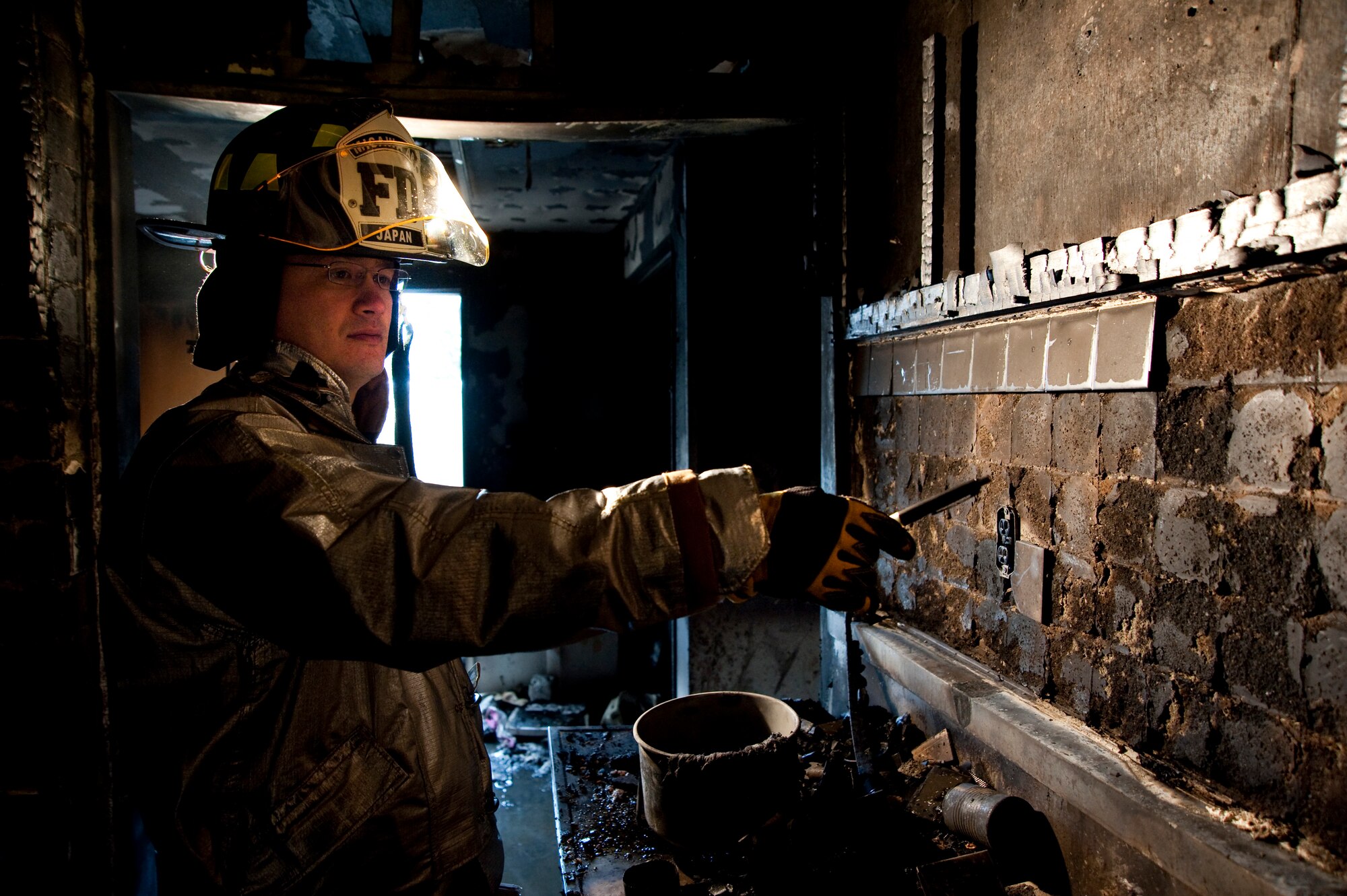 MISAWA AIR BASE, Japan -- Master Sgt. Lee Manley, 35th Civil Engineer Squadron fire inspector and investigator, points out burn patterns in the kitchen of a Misawa home Feb. 12. The fire reinforced Sergeant Manley's advice to Misawa residents to keep renter's insurance, not leave cooking unattended and to crawl below the smoke to exit a burning building safely. (U.S. Air Force photo/Staff Sgt. Samuel Morse)
