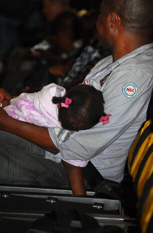 Joseph Etienne holds his 14-month-old daughter Jessica on a flight aboard a C-17 on their way to Charleston International Airport Feb. 6. Mr. Etienne planned to travel to Boston once he arrived in South Carolina to begin rebuilding his life after the loss of his wife in the Jan. 12 earthquake which struck Haiti. (U.S. Air Force photo/Staff Sgt. Daniel Bowles)