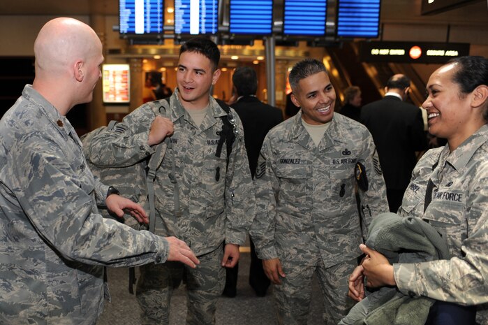 NELLIS AIR FORCE BASE, Nev.-- Maj. Eric Springer, commander of the 99th Security Forces Squadron, and Senior Master Sgt. Gabriel Gonzalez talk with Senior Airman Jeremy Melvin and Airman 1st Class Tanja Kambel at the airport after returning from a deployment.   Approximately 25 members of the 99th SFS returned Jan. 31 from a deployment to Southwest Asia.  (U.S. Air Force photo by Tech. Sgt. Langford Saturnio)