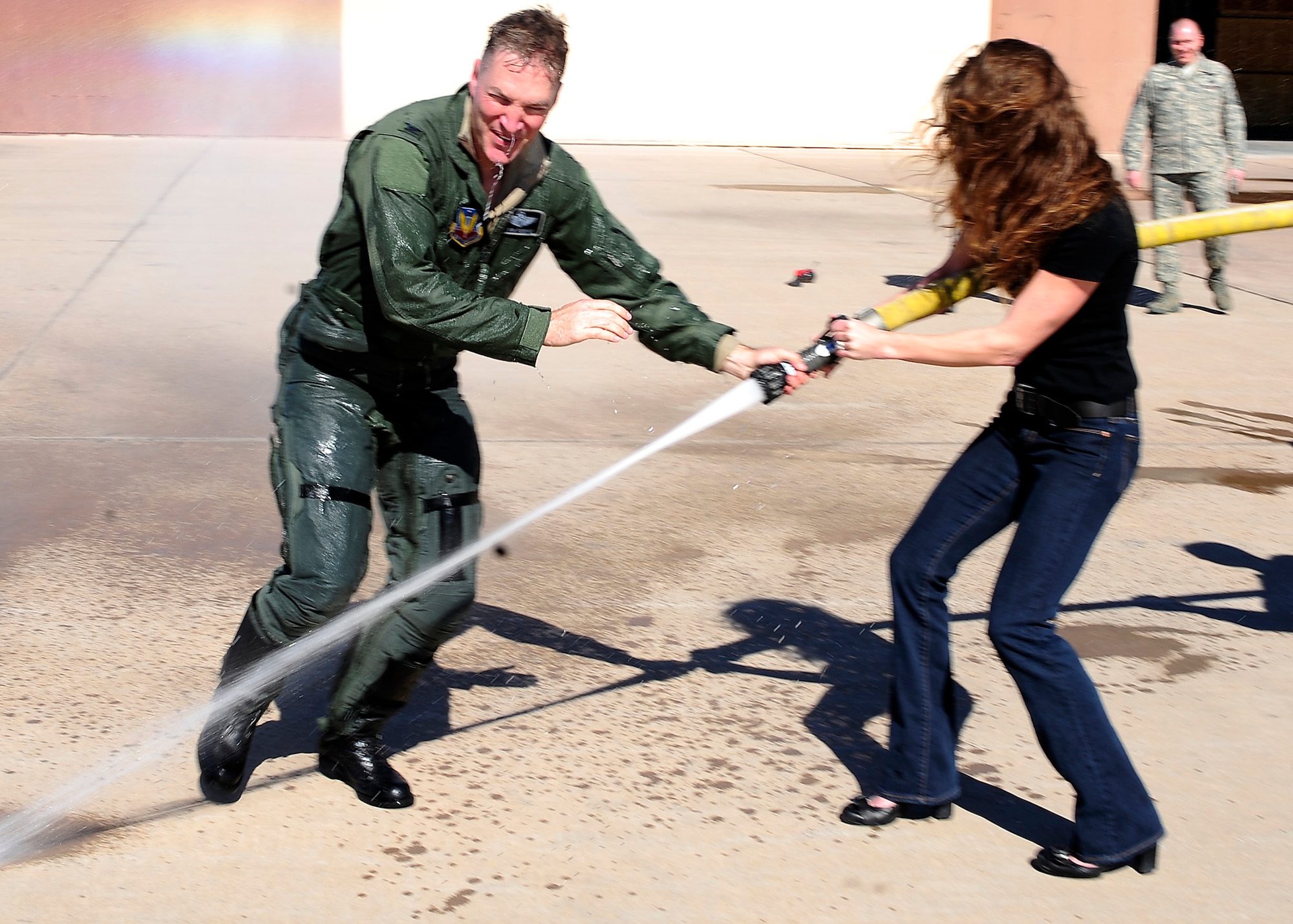 HOLLOMAN AIR FORCE BASE, N.M. -- Col. Kevin "Hollywood" Robbins, 49th Fighter Wing vice commander, gets hosed down with water by his wife Kristine, after his final flight with the 49th Fighter Wing at the 7th Fighter Squadron, Feb. 5. Colonel Robbins entered the Air Force in 1988 as a distinguished graduate from Officer Training School at Lackland AFB, Texas. (U.S. Air Force photo by Senior Airman Deandre Curtiss)