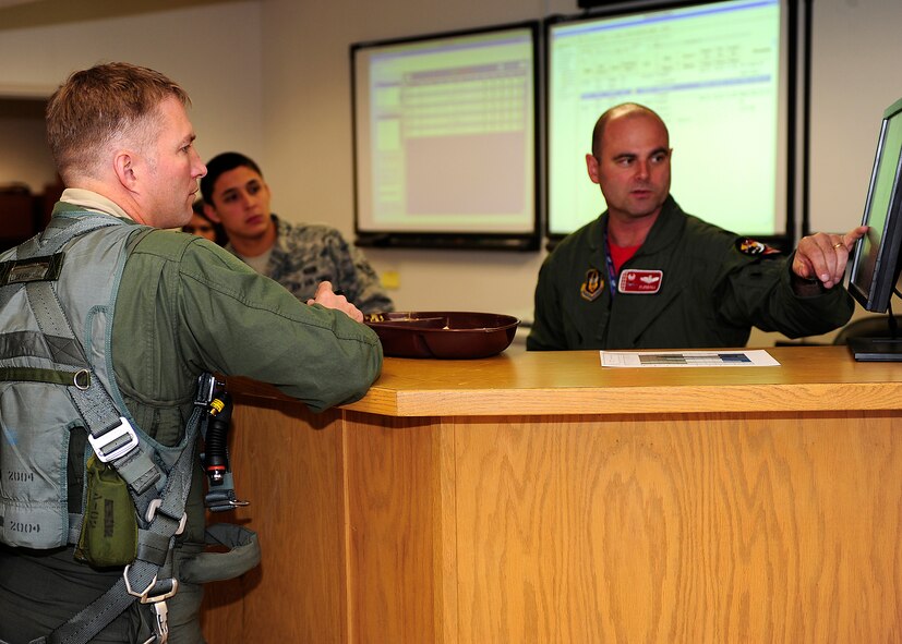 HOLLOMAN AIR FORCE BASE, N.M. -- Col. Kevin "Hollywood" Robbins, 49th Fighter Wing vice commander, receives a briefing on the local conditions in preparation for his final flight with the 49th Fighter Wing, Feb. 5. Colonel Robbins is a command pilot with more than 3,600 flight hours in the F-22 Raptor, F-15 Eagle and F-16 Fighting Falcon. (U.S. Air Force photo by Senior Airman Deandre Curtiss)