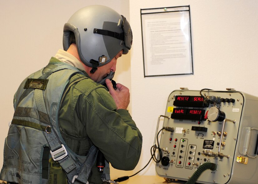 HOLLOMAN AIR FORCE BASE, N.M. -- Col. Kevin "Hollywood" Robbins, 49th Fighter Wing vice commander, checks his flight helmet mask to make sure that it is functioning properly before his final flight with the 49th Fighter Wing, Feb. 5. Colonel Robbins has been assigned to Holloman since August 11, 2009. (U.S. Air Force photo by Senior Airman Deandre Curtiss)