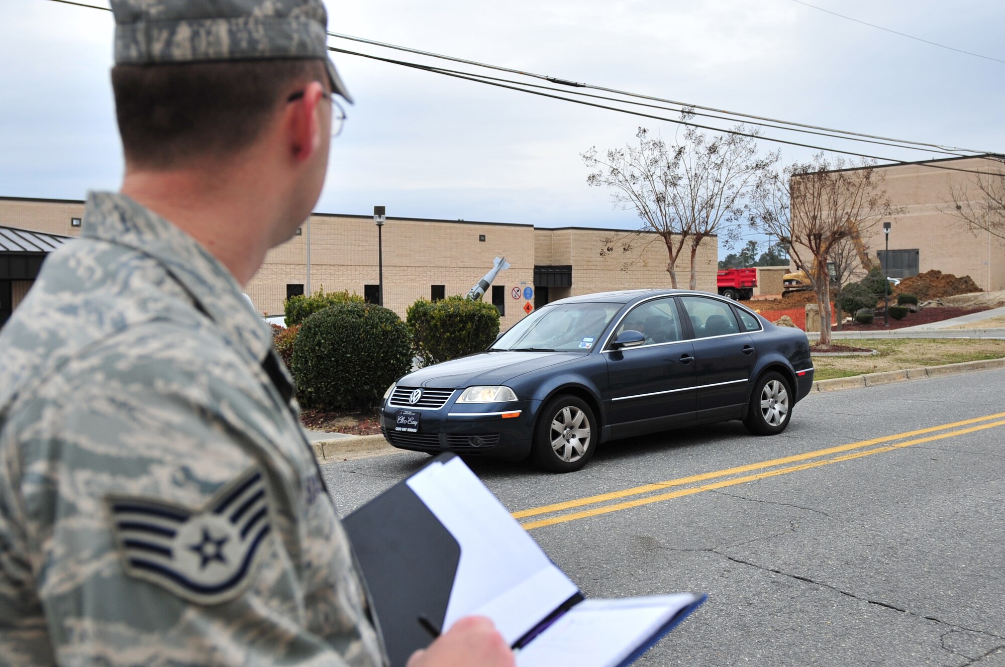 Staff Sgt. Shaun Bassett, 4th Fighter Wing ground safety apprentice, checks to see if people driving past are wearing seatbelts on Seymour Johnson Air Force Base, N.C., Feb. 9, 2010. The safety office surveys various locations around base to get an idea of how many vehicle operators and passengers abide by the law. Bassett hails from Milltown, Ind. (U.S. Air Force photo/Senior Airman Rae Perry)