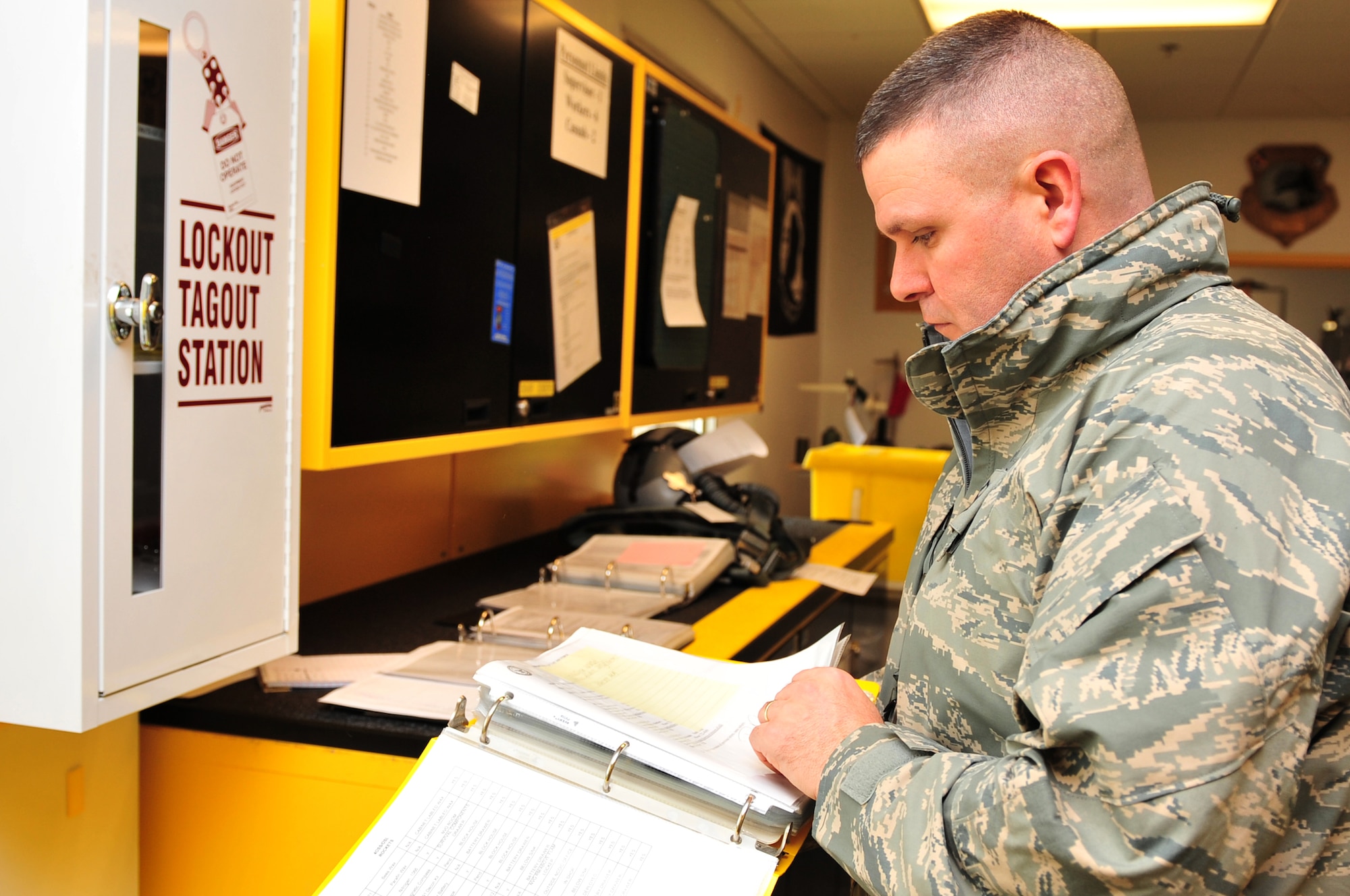 Master Sgt. Michael Wilson, 4th Fighter Wing ground safety superintendent, reviews a log book for a lockout-tagout at the 336th Fighter Squadron life support section on Seymour Johnson Air Force Base, N.C., Feb. 9, 2010. The lockout-tagout program is a tool used to control hazardous energy and prevent the use of unserviceable equipment such as a broken table saw. Wilson hails from Pax, W. Va. (U.S. Air Force photo/Senior Airman Rae Perry)