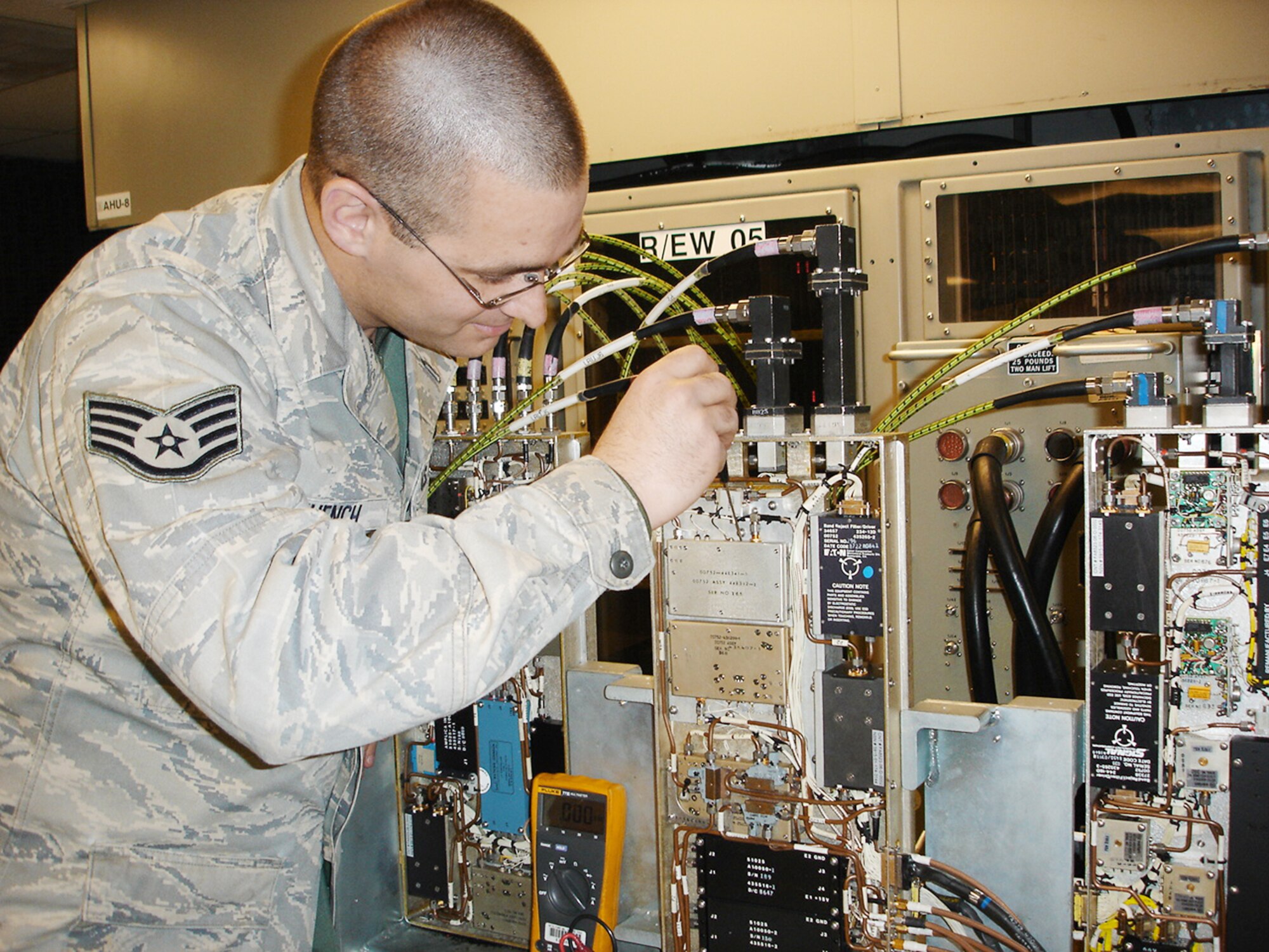 Staff Sgt. Karl Muench Jr. makes frequency adjustments to a B-1B Lancer Band 4-8 receiver mounted on a test station.  The Band 4-8 receiver recently underwent a Repair Network Integration proof-of-concept live test that demonstrated the ability of the repair network to re-optimize and balance capacities to meet a workload requirement of 15 serviceable receivers within a 90-day period.  Sergeant Muench is assigned to the 7th Component Maintenance Squadron at Dyess Air Force Base, Texas.  (U.S. Air Force Photo/MSgt Kenneth Bamberger)