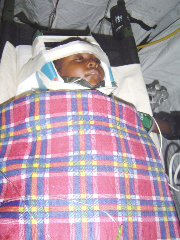 A 4-year-old girl with a cervical fracture and spinal cord injury had her neck immobilized by a critical care air transport team from Keesler Air Force Base, Miss., during a C-130 Hercules flight from Haiti to a medical facility in Florida Feb. 7, 2010. Keesler AFB CCAT teams are providing medical care to victims of the Haiti earthquake who are airlifted to hospitals in the United States. (U.S. Air Force photo/Maj. (Dr.) Stephen Boskovich)
