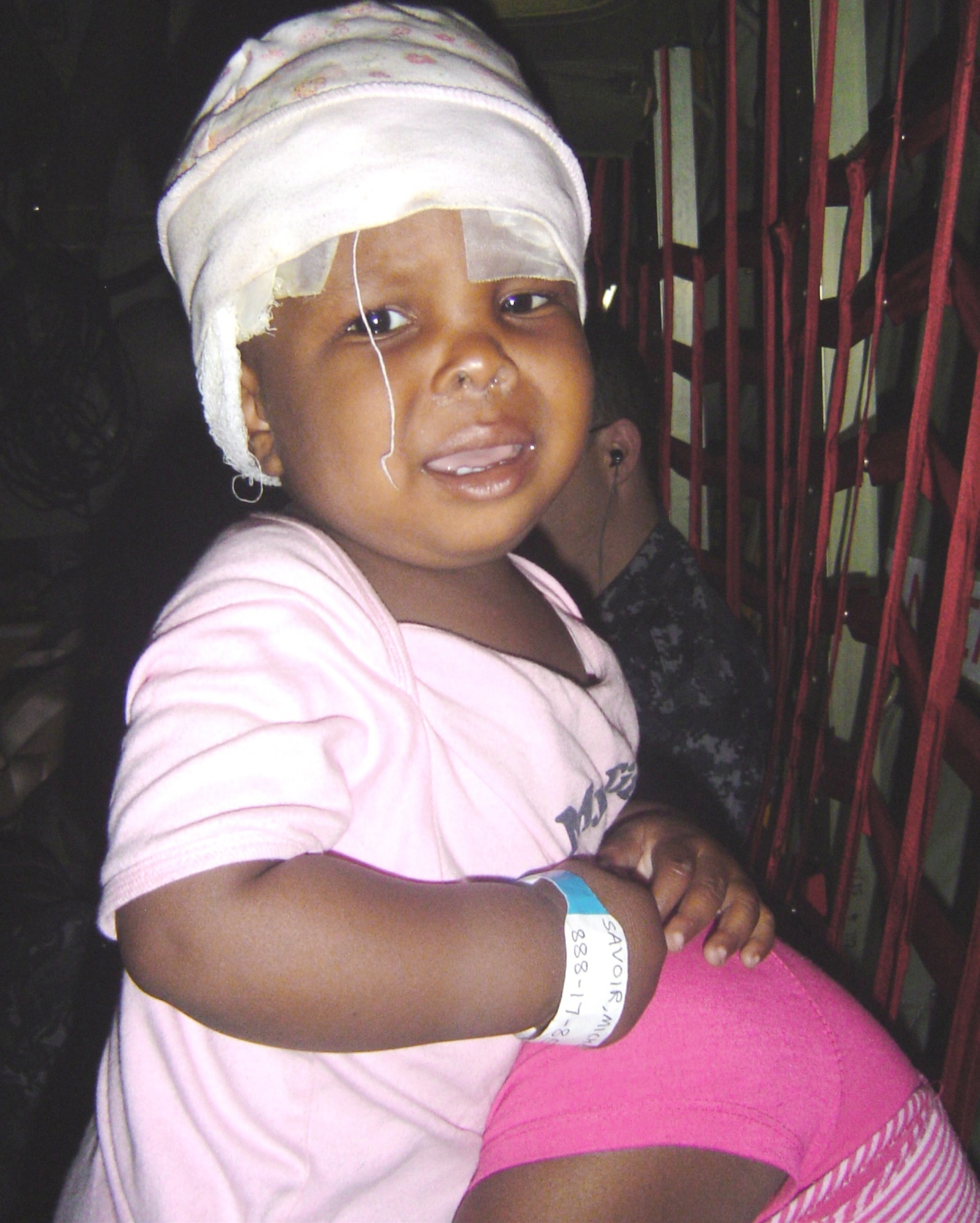 A 13-month-old girl with a skull fracture is transported on a C-130 Hercules Feb. 7, 2010, to a medical facility in the United States by a critical care air transport team from Keesler Air Force Base, Miss. Keesler AFB CCAT teams are providing medical care to victims of the Haiti earthquake who are airlifted to hospitals in the United States. (U.S. Air Force photo/Maj. (Dr.) Stephen Boskovich)