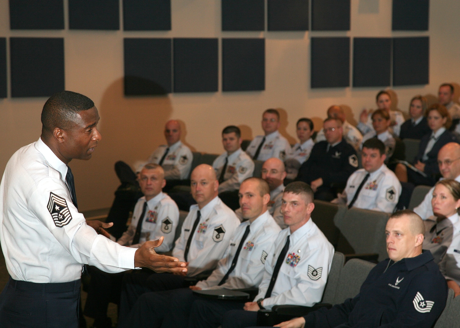 Chief Master Sgt. Juan Lewis, 502nd Air Base Wing command chief, welcomes Airmen to the Additional Duty First Sergeant Seminar at the Inter-American Air Forces Academy auditorium Feb. 8. The week-long seminar provided NCOs and Senior NCOs serving as additional duty or backup first sergeants the training they need to fulfill key leadership roles when the need arises. (U.S. Air Force photo/Robbin Cresswell)