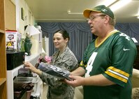 Darrell Stuebs helps Senior Airman Darlene Mott-Neve, 59th Laboratory Squadron, find items at the Airman's Attic. Mr. Stuebs is the volunteer manager of the facility, which helps junior Airmen in need of household items, uniforms and uniform accessories. (U.S. Air Force photo/Robbin Cresswell) 