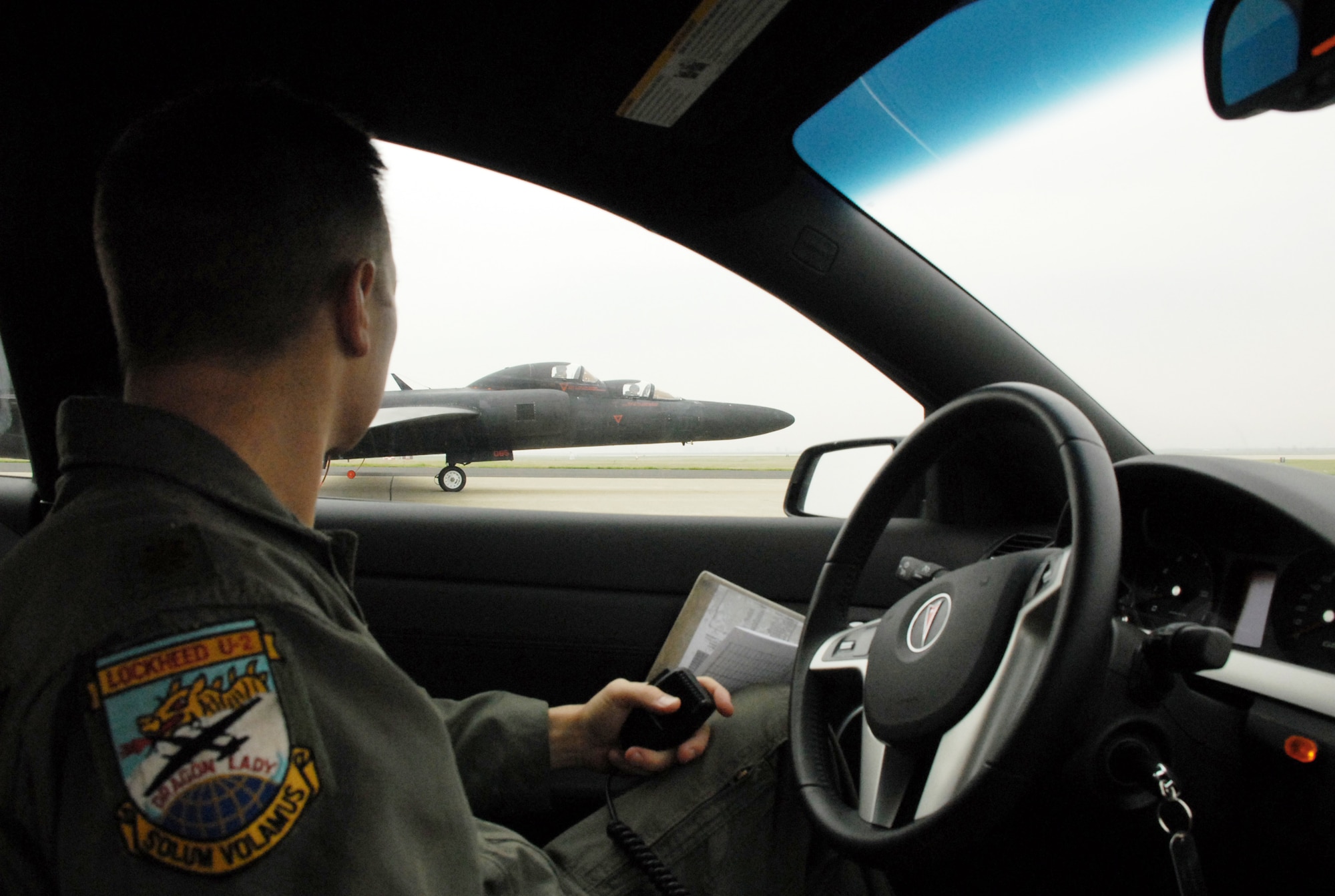 Maj. Luke Lokowich, with the 1st Reconnaissance Squadron at Beale Air Force Base, Calif., drives around a U-2 reconnaissance aircraft on the runway at Beale AFB Feb. 4, 2010, while keeping in constant contact with the pilot in the cockpit. The U-2 chase car is the pilot's extra eyes and ears on the ground during flight operations. (U.S. Air Force photo/Tech. Sgt. Luke Johnson)