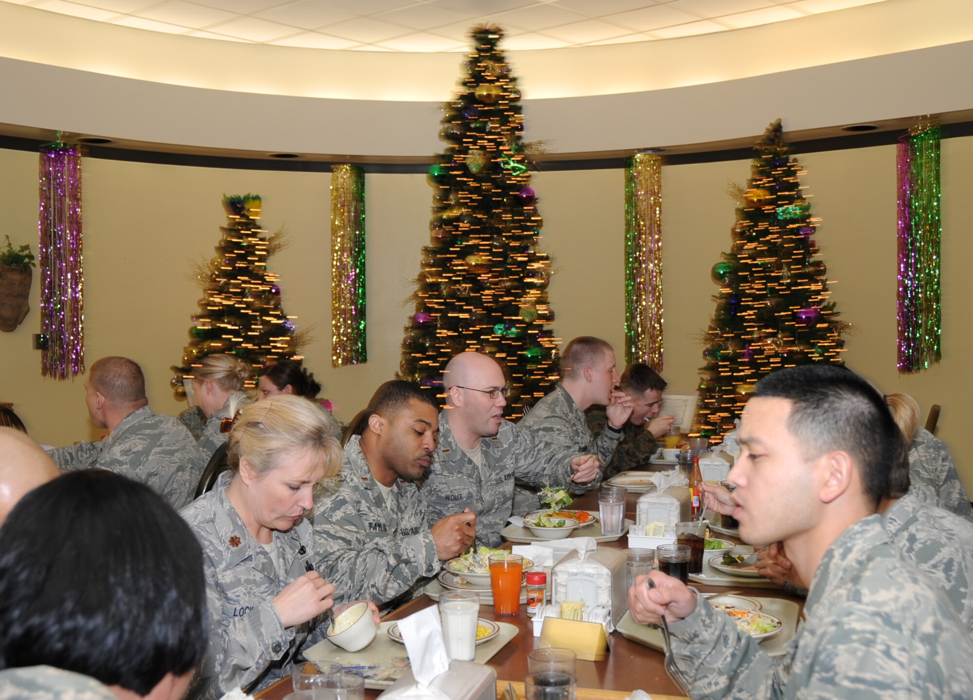 Mardi Gras trees decorated in seasonal green, gold and purple provide the background as students from the force support officers course in the 335th Training Squadron eat lunch Feb. 4 at the Live Oak Dining Facility.  An evaluation team representing the Air Force Services Agency and the food industry is judging Keesler’s food service program today and Friday as part of the Air Force’s John L. Hennessy Award competition.  Keesler is Air Education and Training Command’s nominee in the multiple facility category.  (U.S. Air Force photo by Kemberly Groue)