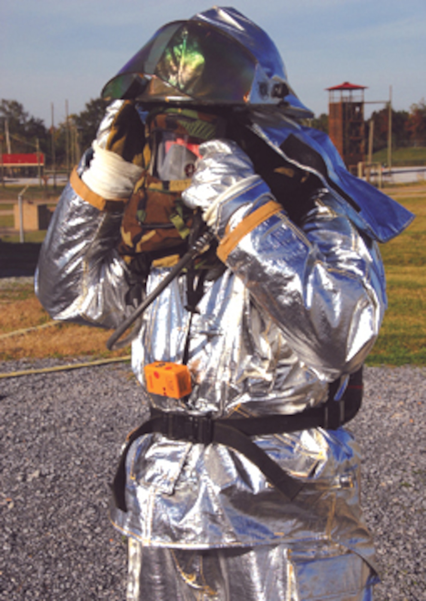 Tech. Sgt. Christopher Foley of the 908th Airlift Wing Civil Engineering Squadron prepares for a structural fire exercise in a chemical environment. The civil engineer squadron Reservists, who bring their civilian firefighting skills to the wing, endure not only the usual protective suit, but MOPP 4 gear as well when working in a chemical environment.
