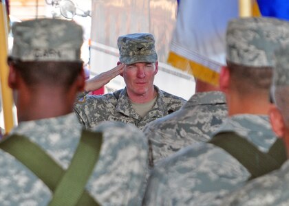 Army Col. Gregory Reilly salutes his Soldiers, Airmen, Sailors and Marine as he assumes command of Joint Task Force-Bravo from Air Force Col. Eric Snadecki during a change of command ceremony at the Soto Cano Fire Department February 9. (U.S. Air Force Photo/Staff Sgt. Bryan Franks)