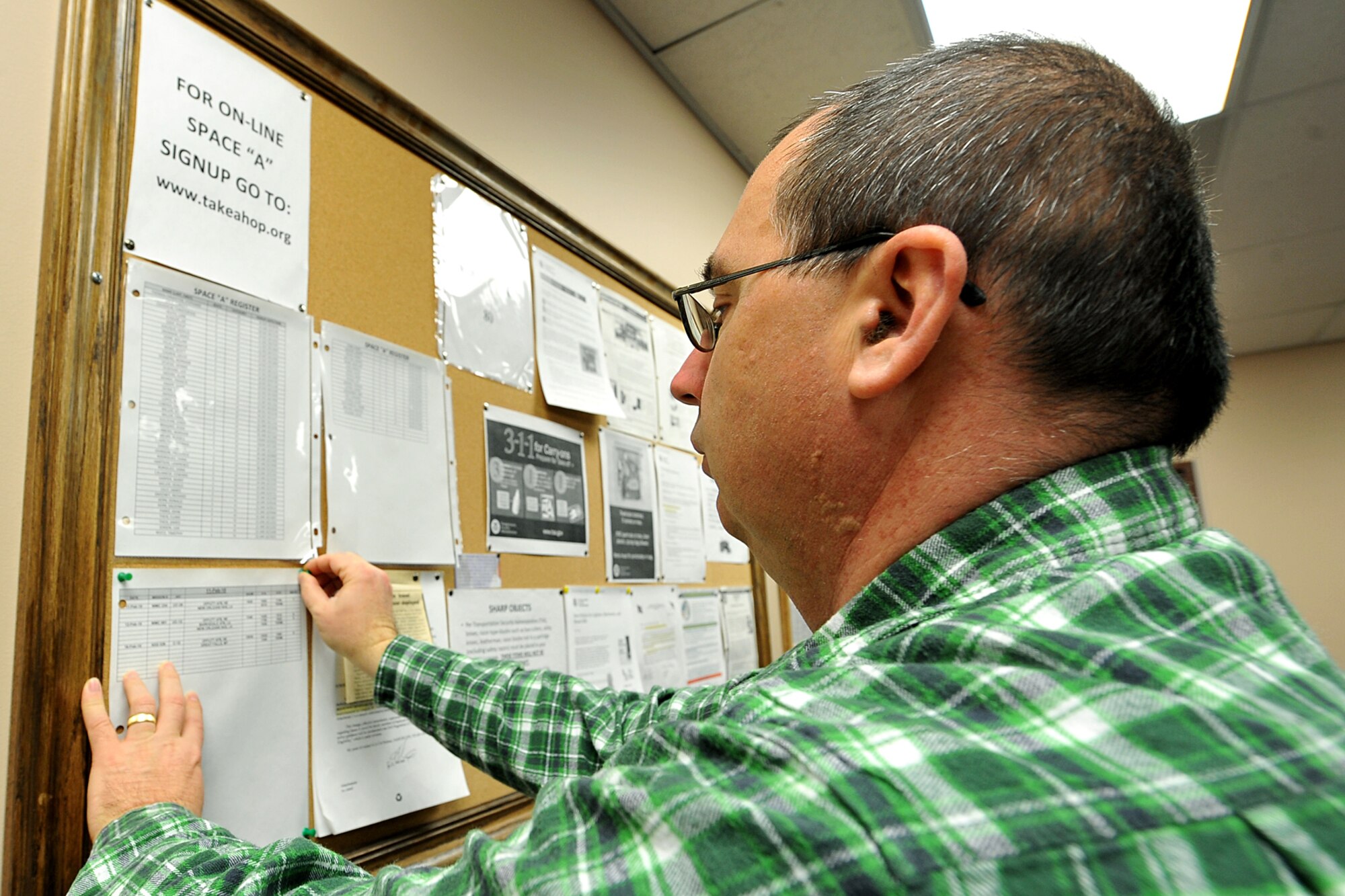 OFFUTT AIR FORCE BASE, Neb. -- Tom Kovy, logistics management specialist with the 55th Mission Support Group, posts the latest flight schedule at the passenger terminal here Feb. 11. Space-available flights for military members, family members and military retirees to places such as Peterson AFB, Colo., Scott AFB, Ill., and Andrews AFB, Md., are available from Offutt. 

U.S. Air Force photo by Charles Haymond