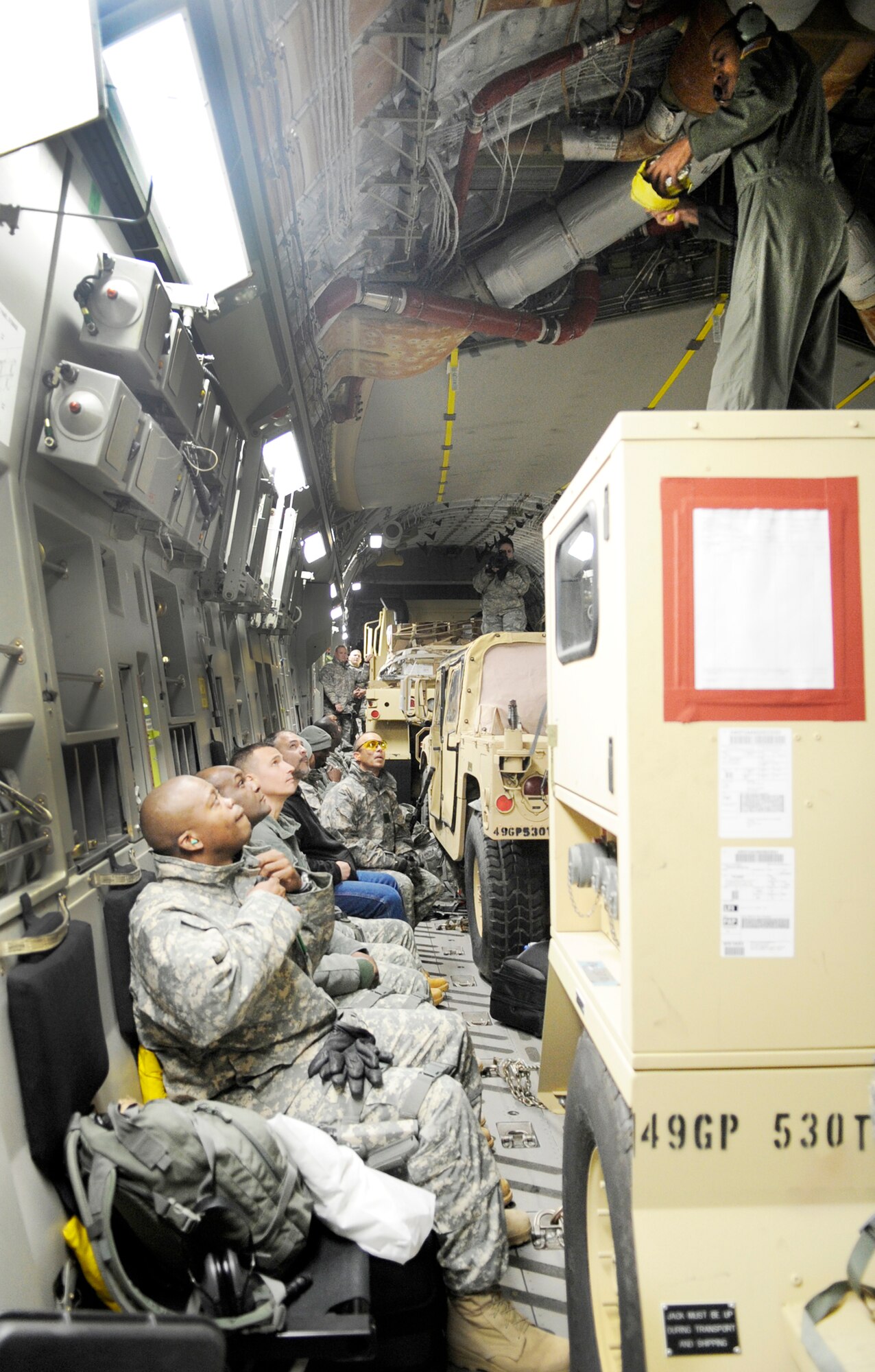Servicemembers from Fort Lee, Va. sit aboard a C-17 Globemaster III Feb. 8, 2010, at Langley Air Force Base, Va. Through a joint effort by Soldiers and Airmen from Joint Base Langley-Eustis, servicemembers and cargo are transported to Haiti as part of Operation Unified Response. (U.S. Air Force Photo/Senior Airman Dana Hill)