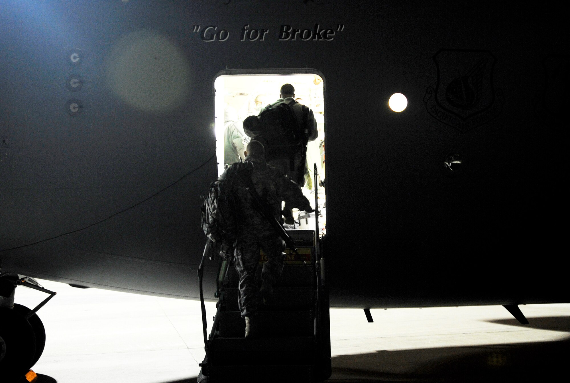 Servicemembers board a C-17 Globemaster III Feb. 8, 2010, at Langley Air Force Base, Va. Through a joint effort by Soldiers and Airmen from Joint Base Langley-Eustis, servicemembers and cargo are transported to Haiti as part of Operation Unified Response. (U.S. Air Force Photo/Senior Airman Dana Hill)