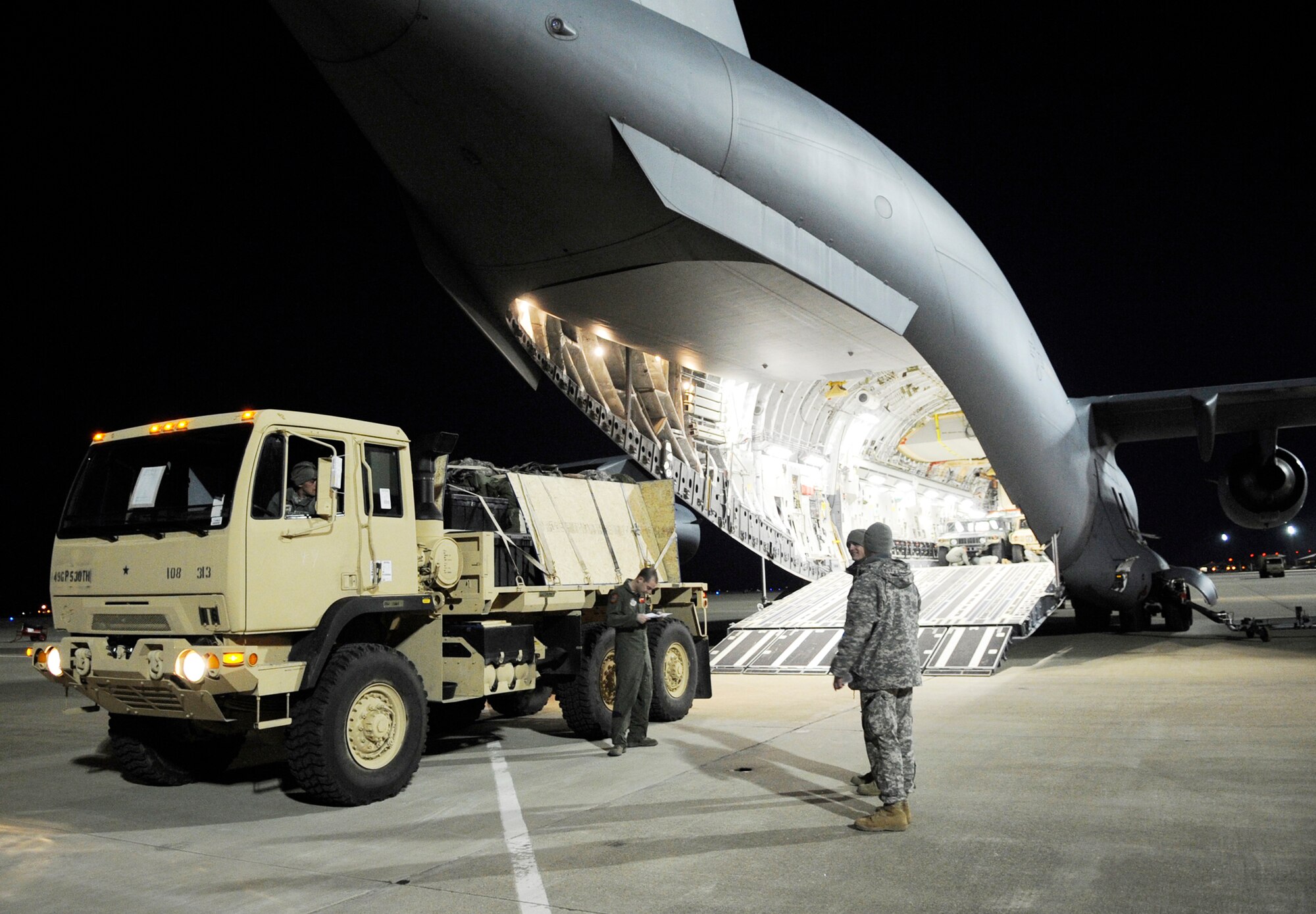 Cargo is loaded onto a C-17 Globemaster III Feb. 8, 2010, at Langley Air Force Base, Va. Through a joint effort by Airmen and Soldiers from Joint Base Langley-Eustis, servicemembers and cargo are transported to Haiti as part of Operation Unified Response. (U.S. Air Force photo/Senior Airman Dana Hill)