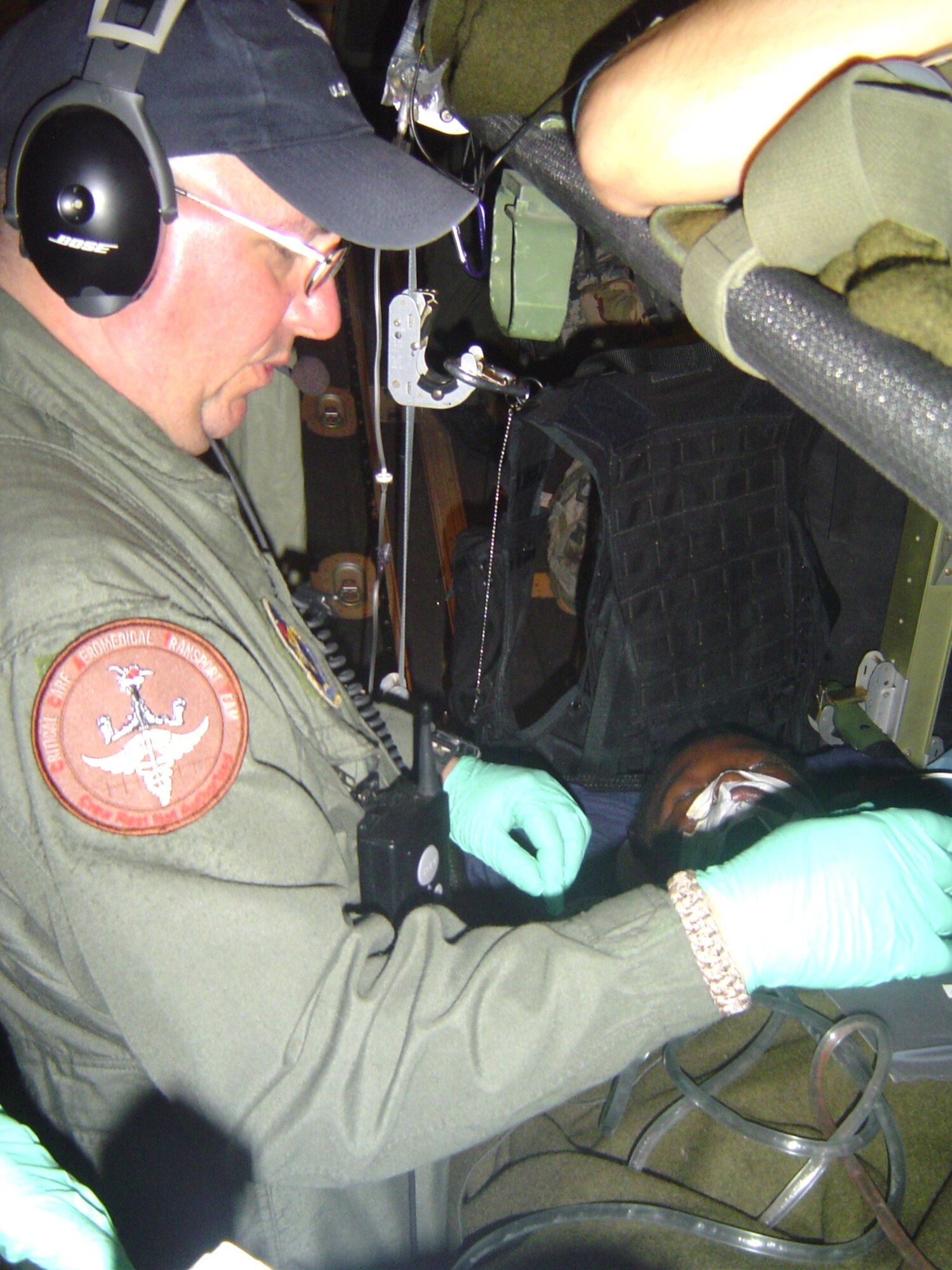 Tech. Sgt. Rich Pakula, 81st Medical Group, respiratory therapist, monitors equipment in flight aboard a C-130 Hercules Feb 7. Keesler CCAT teams are providing medical care to victims of the Haiti earthquake who are airlifted to hospitals in the United States. (U.S. Air Force photo/Maj. (Dr.) Stephen Boskovich)
