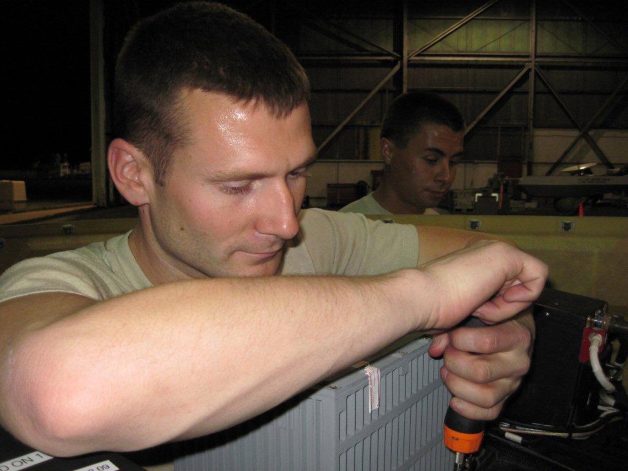 OPERATION UNIFIED RESPONSE -- Staff Sgt. Jake Gauvin, a member of the 849th Aircraft Maintenance Squadron at Holloman Air Force Base, N.M., installs a Multisensor Tactical System turret on a Holloman RQ-1 Predator in support of Operation Unified Response recently. Members from the 849th AMXS teamed up with members of the 432nd Air Expeditionary Wing from Creech AFB, Nev., to provide support to troops on the ground in Haiti. (Courtesy photo)