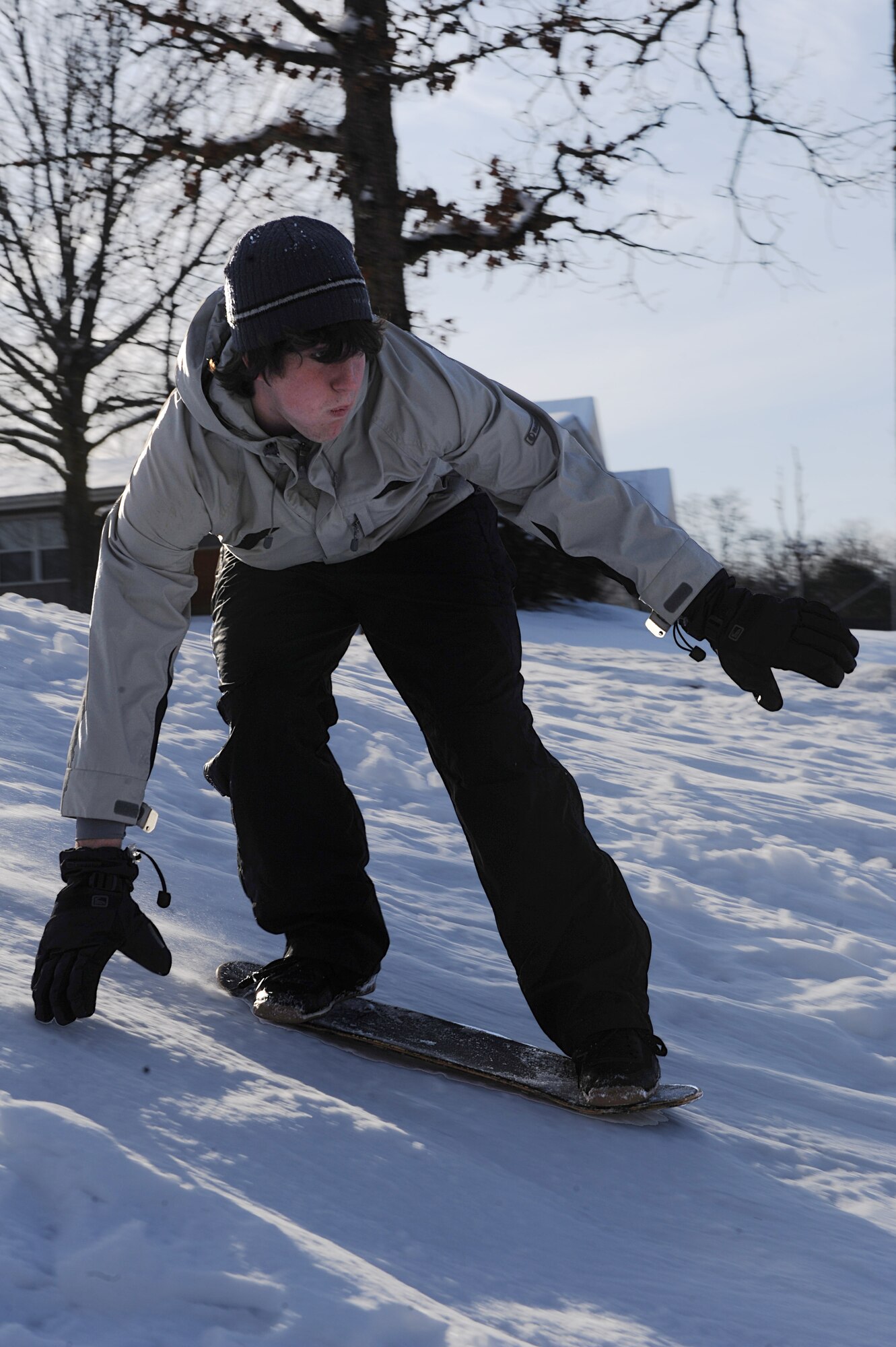 Toby Robinson, son of Lt. Col. Scott Robinson, 62nd Airlift Squadron director of operations, snow boards down a snow-covered hill Feb. 10. The last major snow fall reported in Central Arkansas was in 1988, according to the National Weather Service.   (U.S. Air Force photo by Staff Sgt. Chad Chisholm)